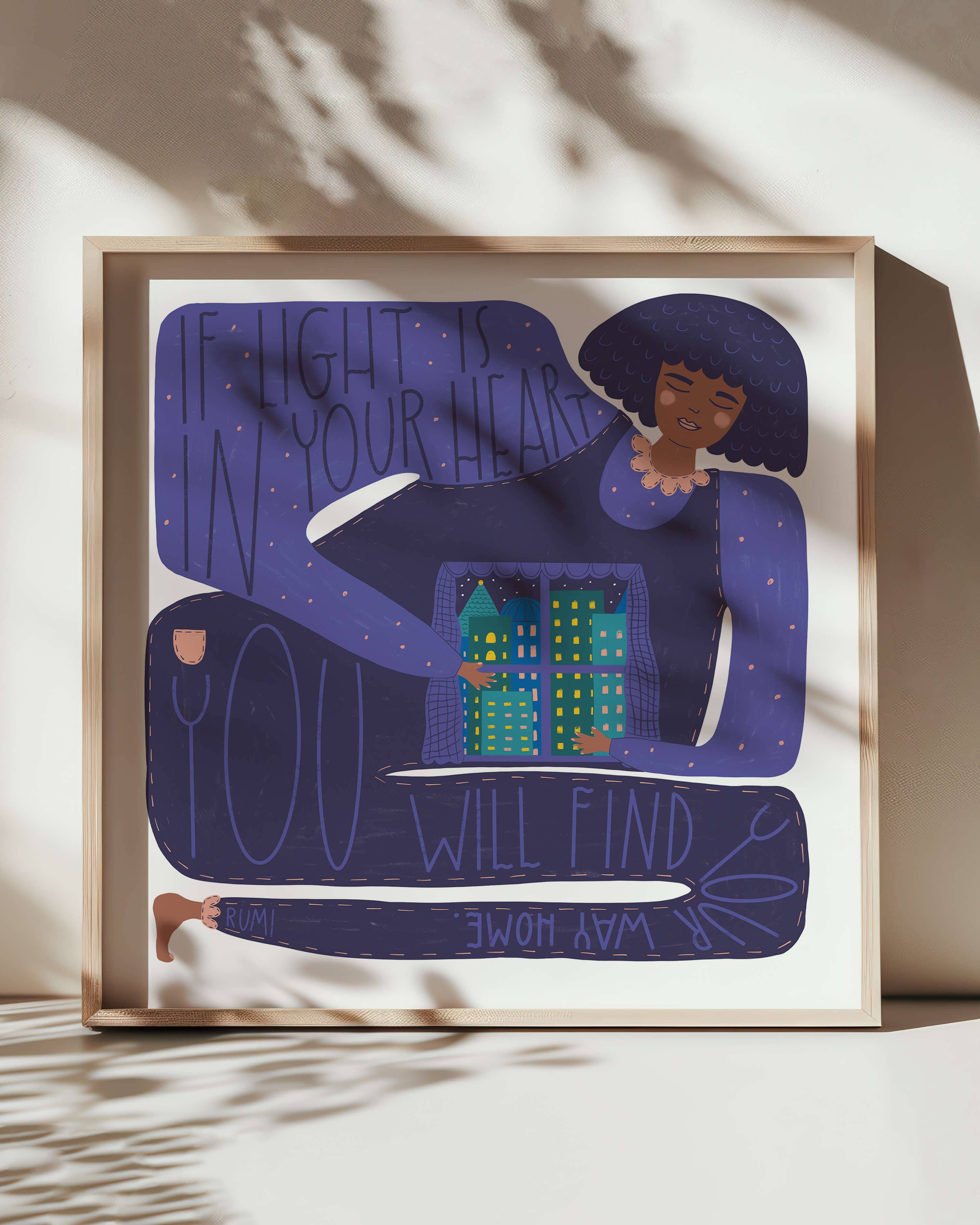 Framed artwork with a stylised illustration of a person holding a cityscape, with text on a light background.