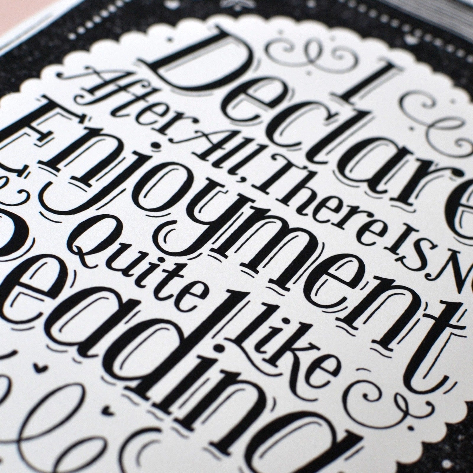 Close-up of decorative black text with intricate lettering on a white background.