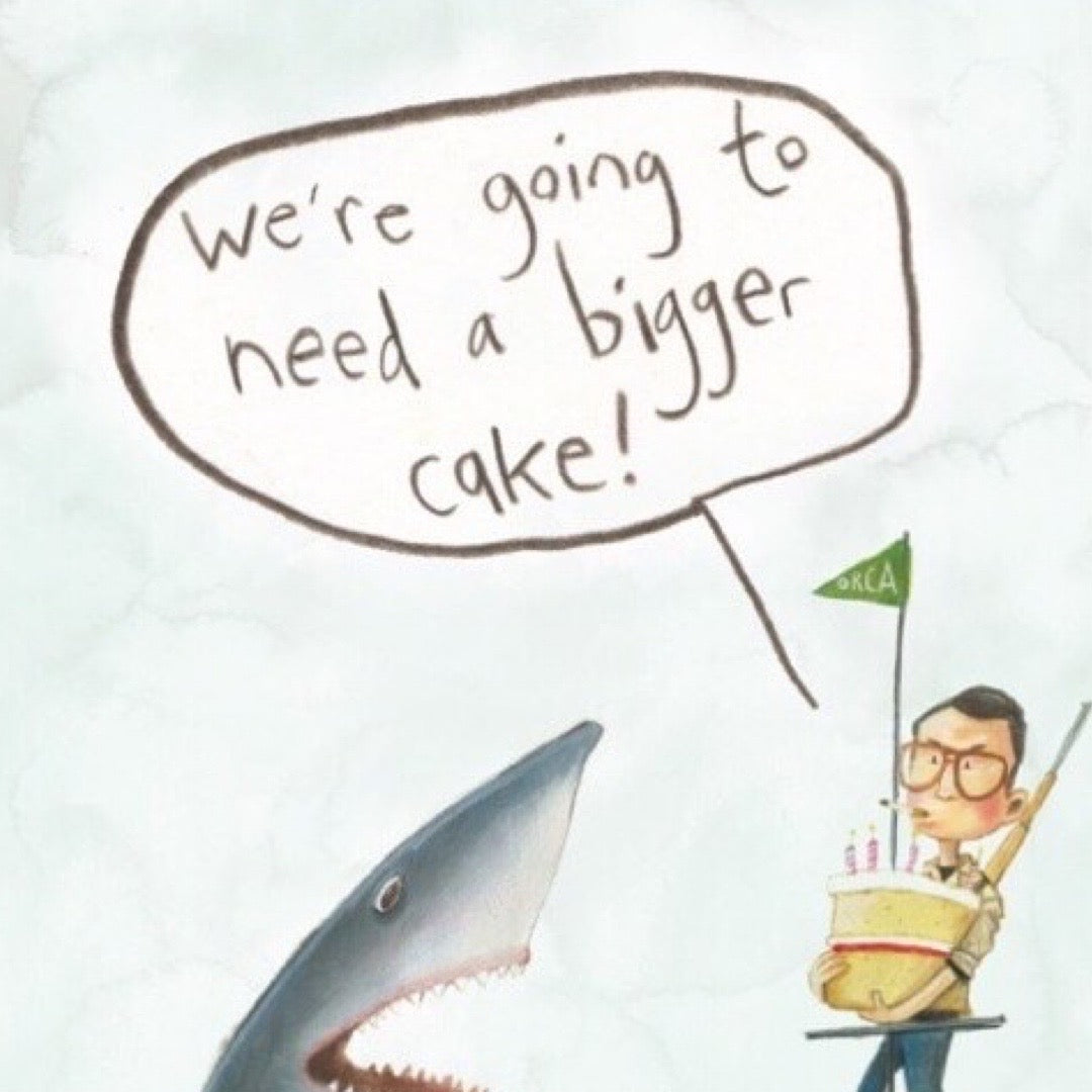 Birthday card with an illustration of Jaws and a man standing on a pontoon holding a small birthday cake and the text 'We're gonna need a bigger cake!'.