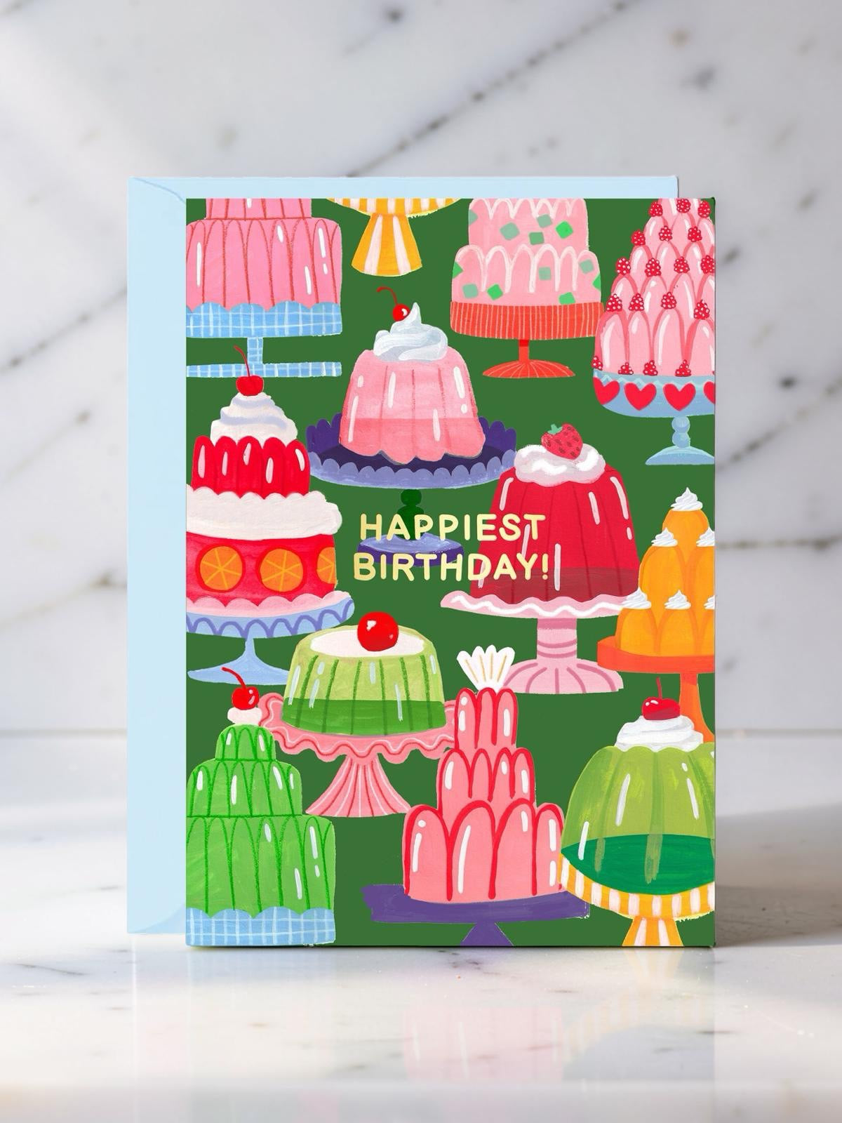 Colourful birthday card with illustrations of jellies on a wooden surface.
