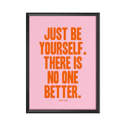 Typography print of the Taylor Swift quote 'Just Be Yourself, There Is No One Better' written in red text against a pink background.