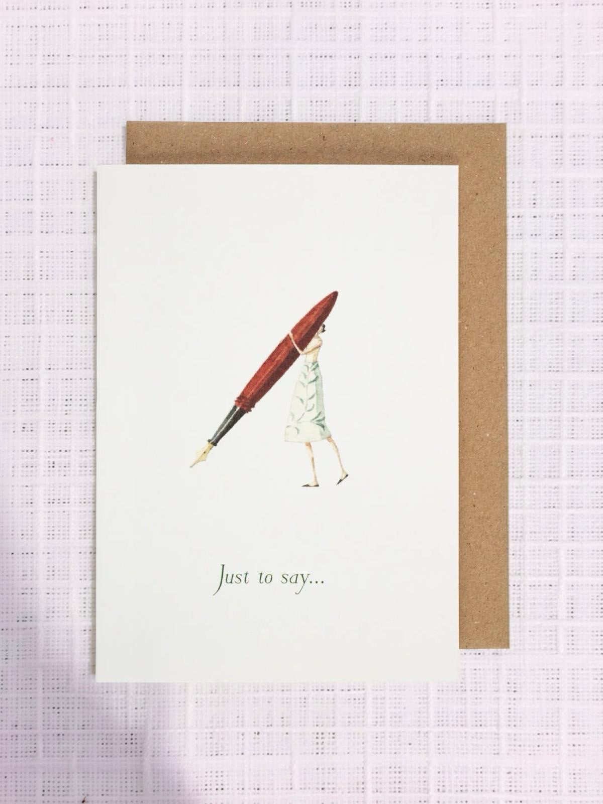 Greeting card with a person holding a pen and envelope on a textured white background.