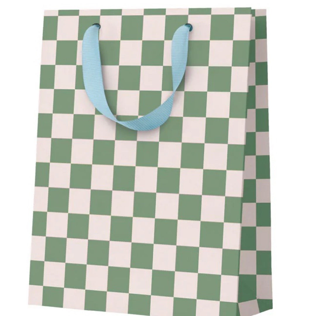 Checkered gift bag with green and white pattern and blue handles on a white background.