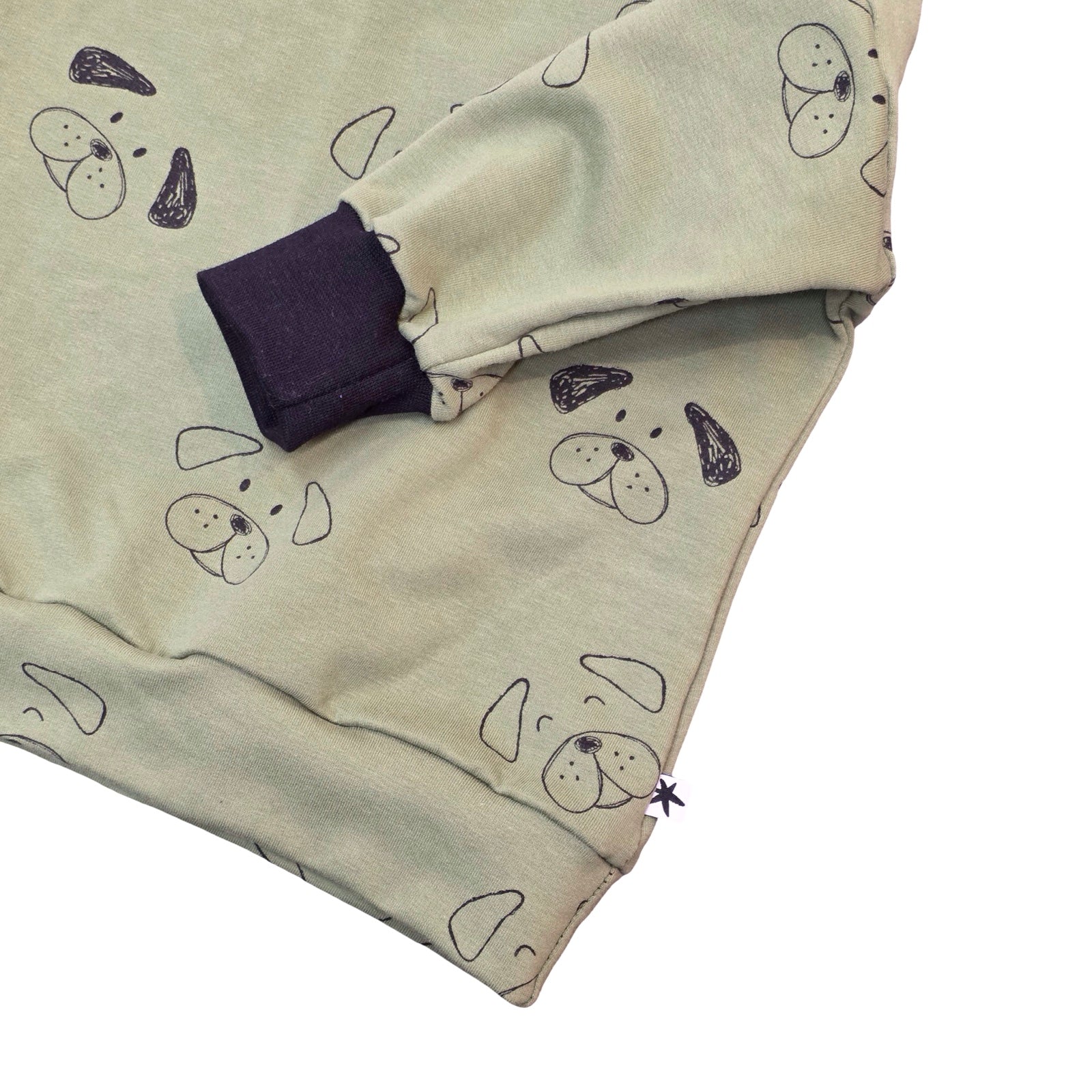 Folded fabric with black pattern on a white background.