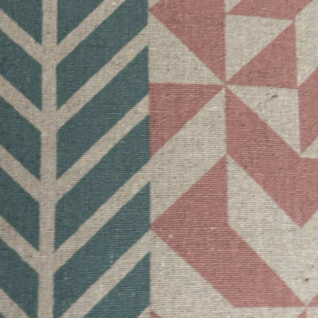 Handmade drum lampshade in panels of pink, grey, navy and cream geometric designs.
