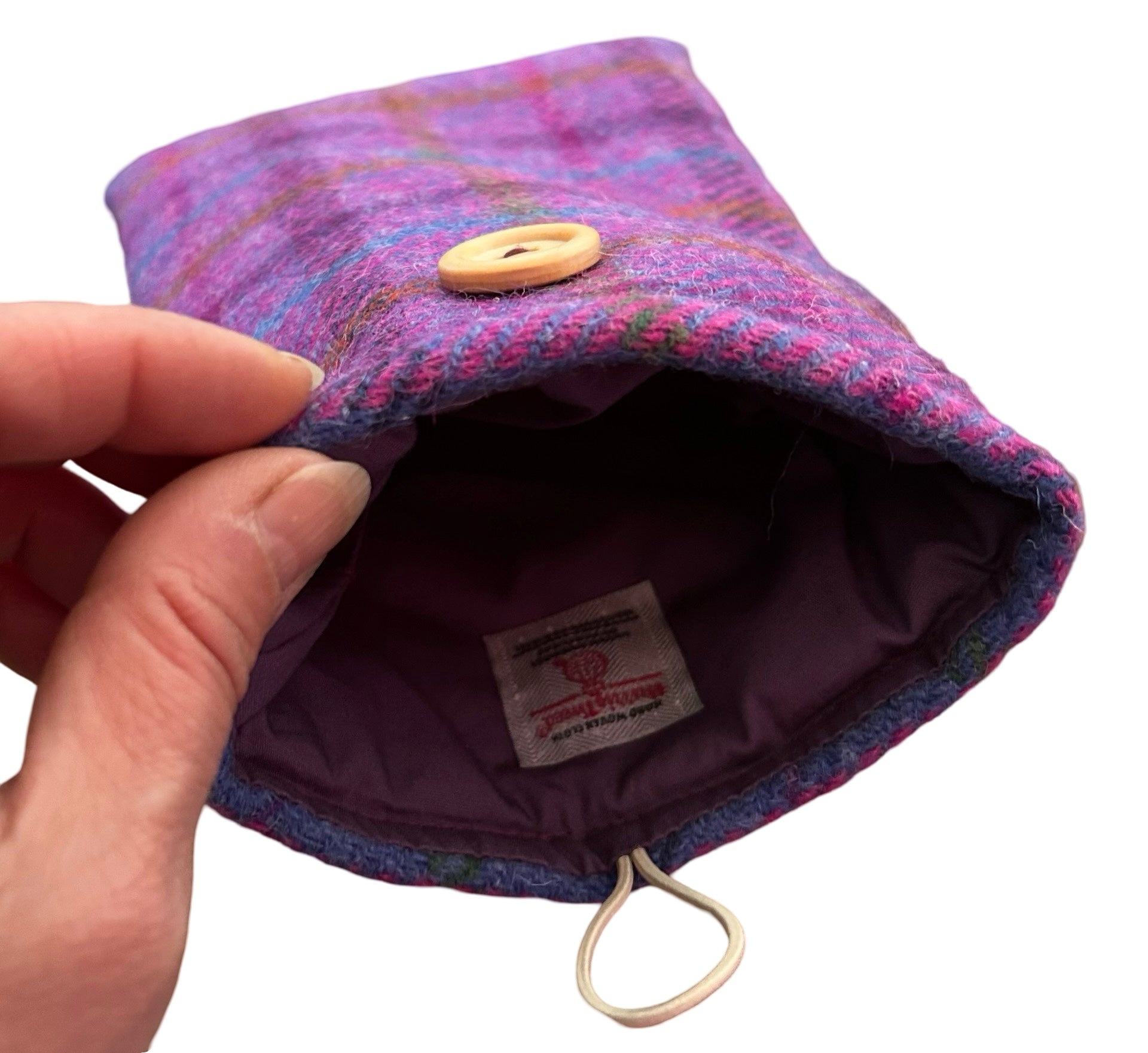 Showing the plain purple cotton inside of the Harris tweed Kindle cover in purple.