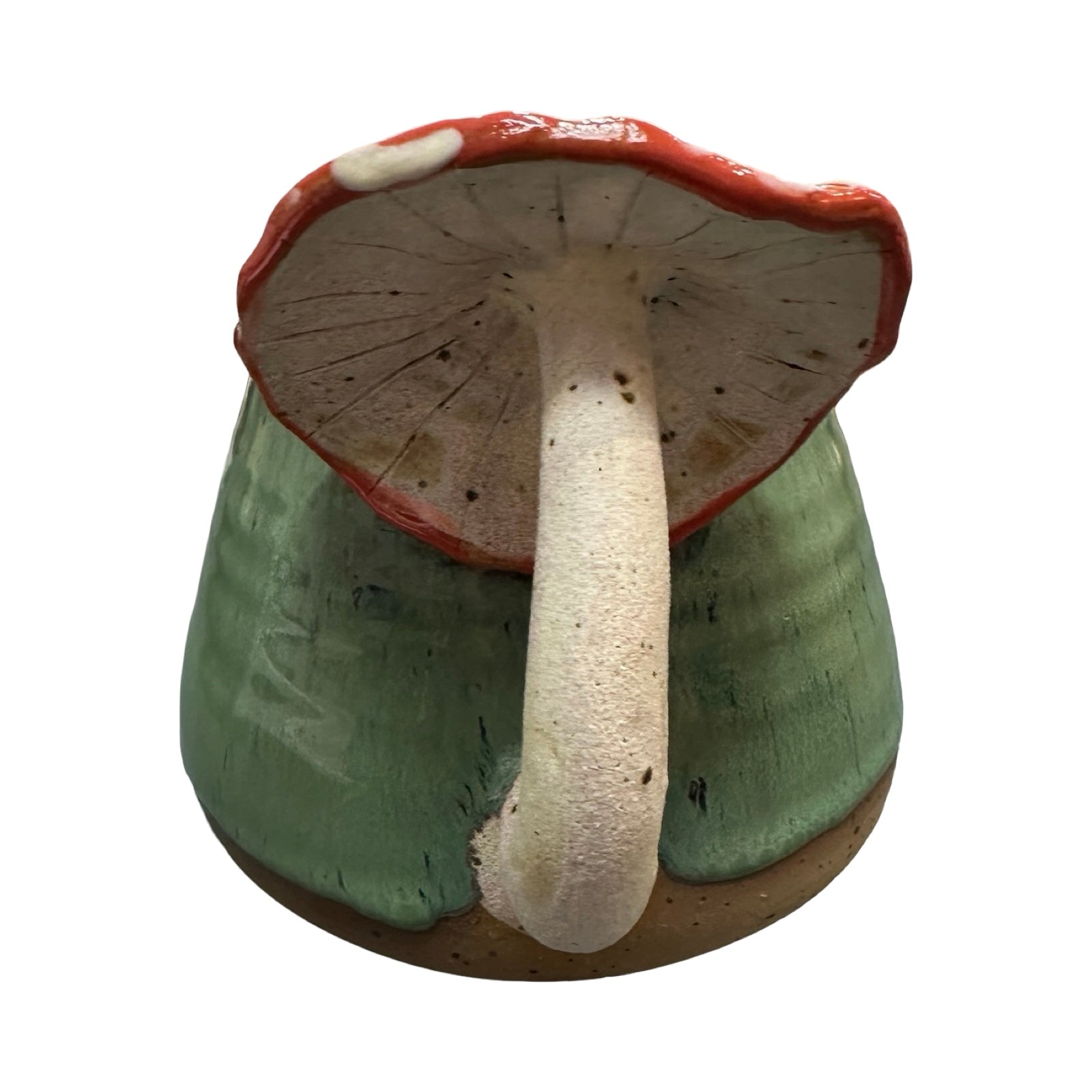 Ceramic mushroom with red mushroom handle on a white background.
