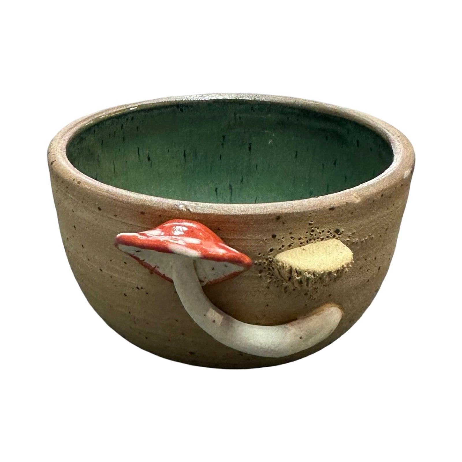 Ceramic trinket dish with mushroom design on a white background.