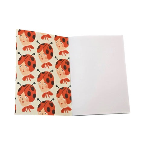 These gorgeous notebooks feature a lady's head wearing a ladybird hat and a large red bow around her neck. 