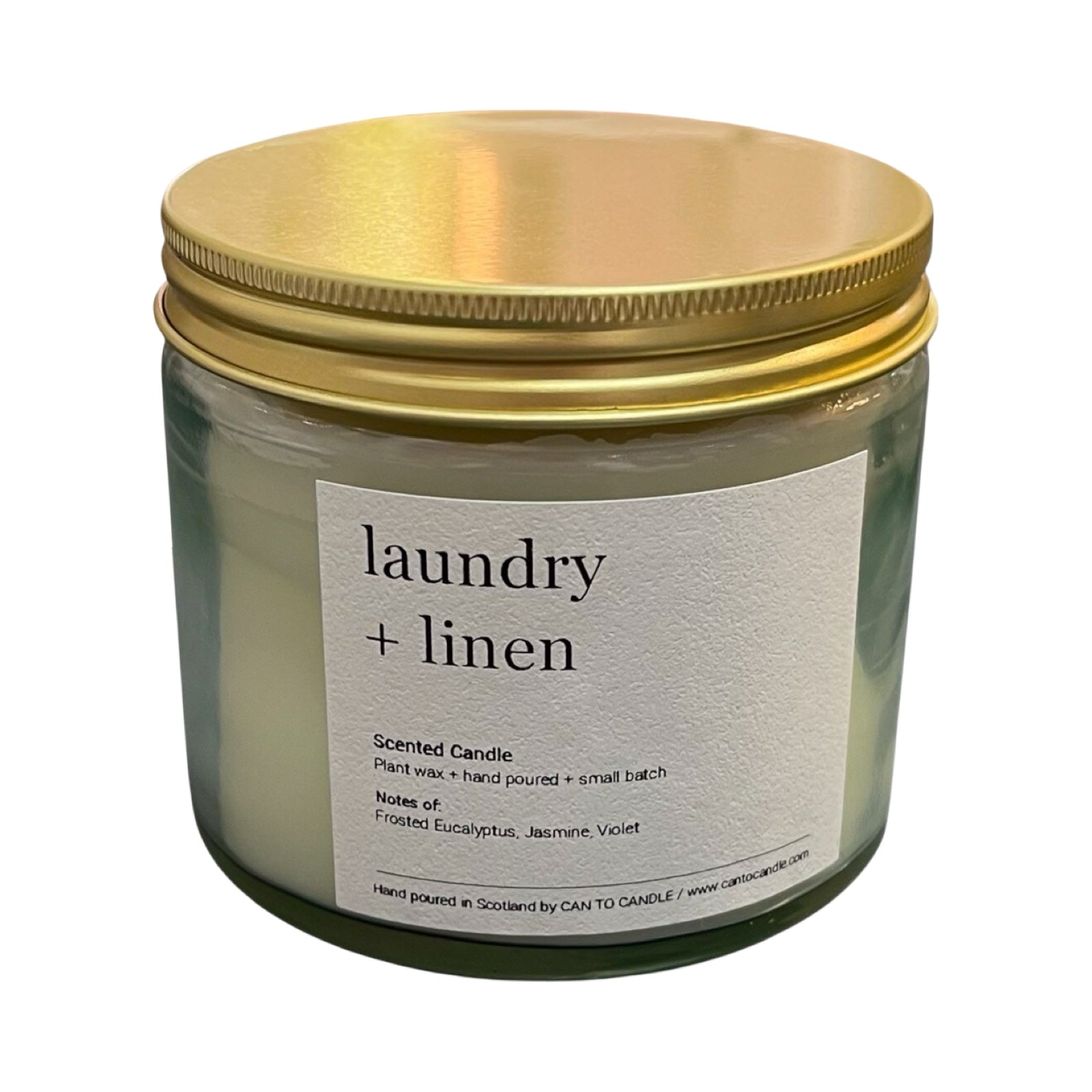 Scented candle labeled 'laundry + linen' with a gold lid on a white background.