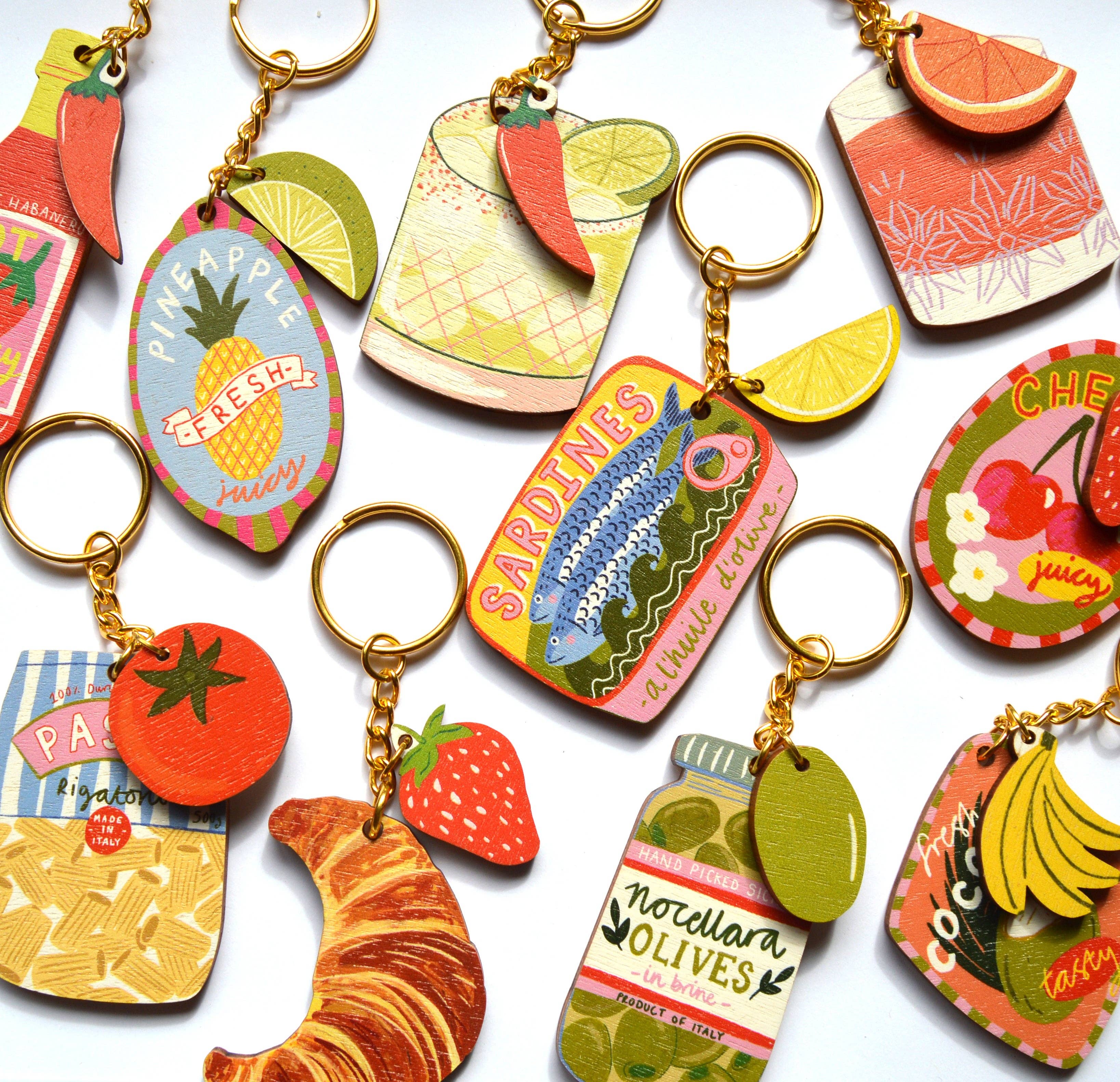 Collection of colourful keychains with various designs on a white background.