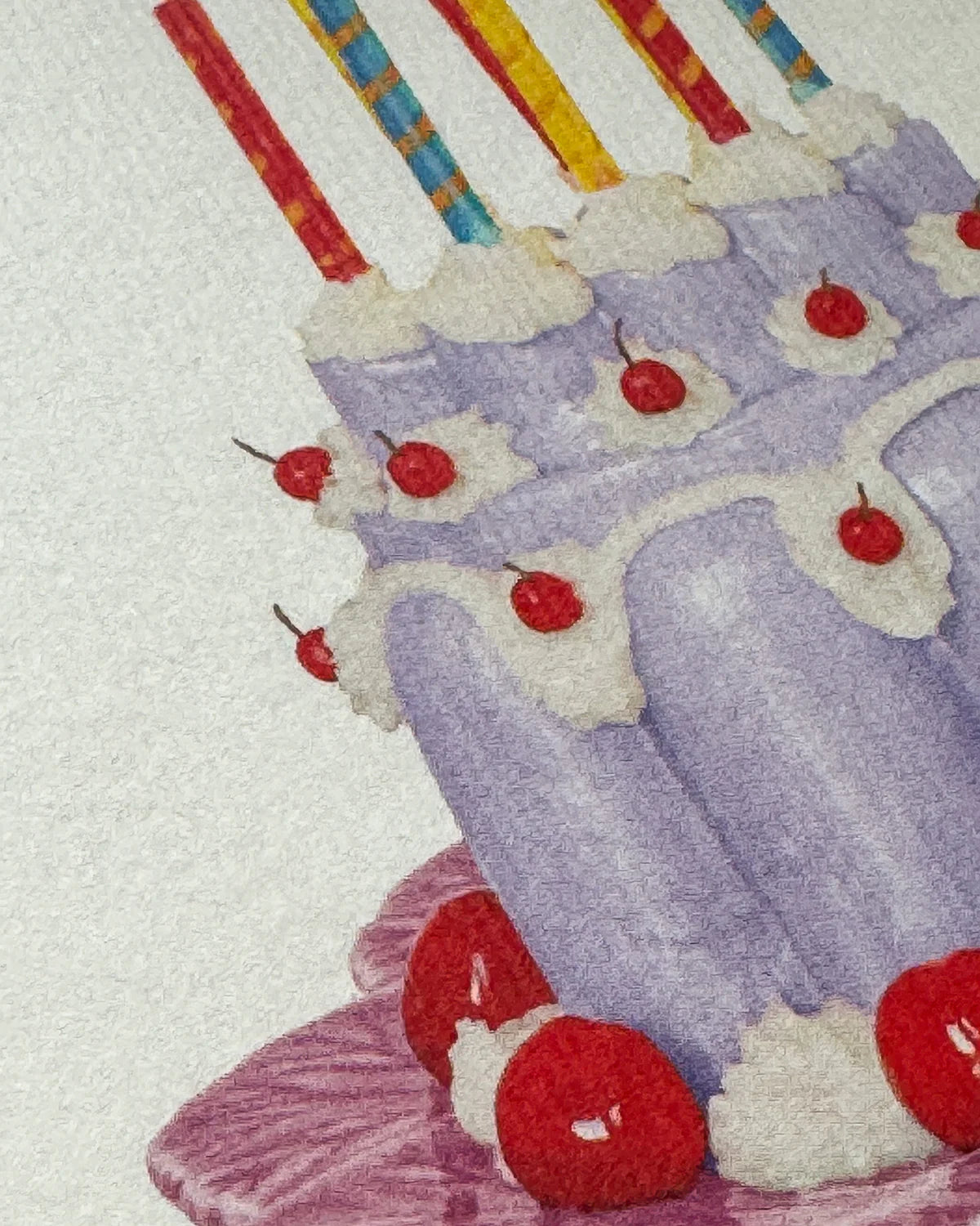Close-up of a card with an illustration of a purple cake with cherries and candles.
