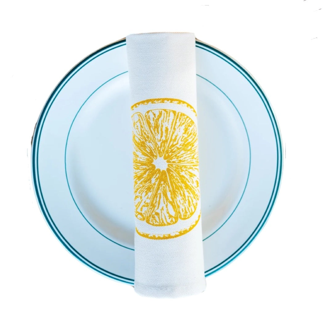 Rolled cotton napkin featuring a yellow lemon slice.