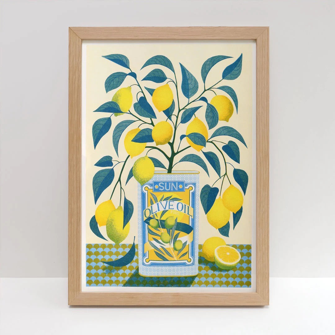 Framed artwork with lemons and olive oil label design on a white background.