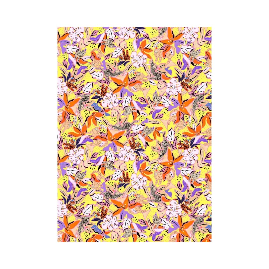 Wrapping paper featuring black and white leopards surrounded by orange, lilac and white flowers on a yellow background.