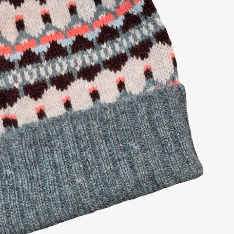 This blue, navy, pink and white striped woollen hat is handmade using only the softest Scottish spun lambswool.