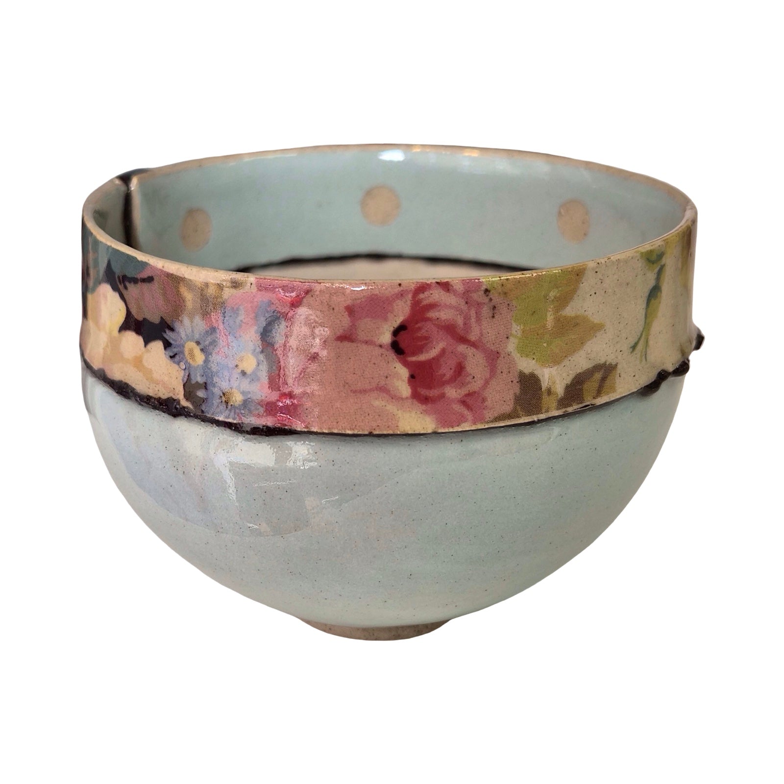 Ceramic bowl with floral patterned rim on a white background.