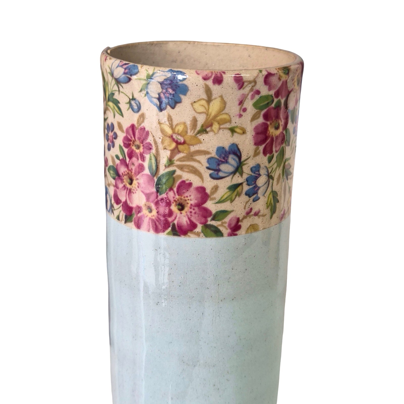 Cylindrical vase with floral patterned top section on a white background.