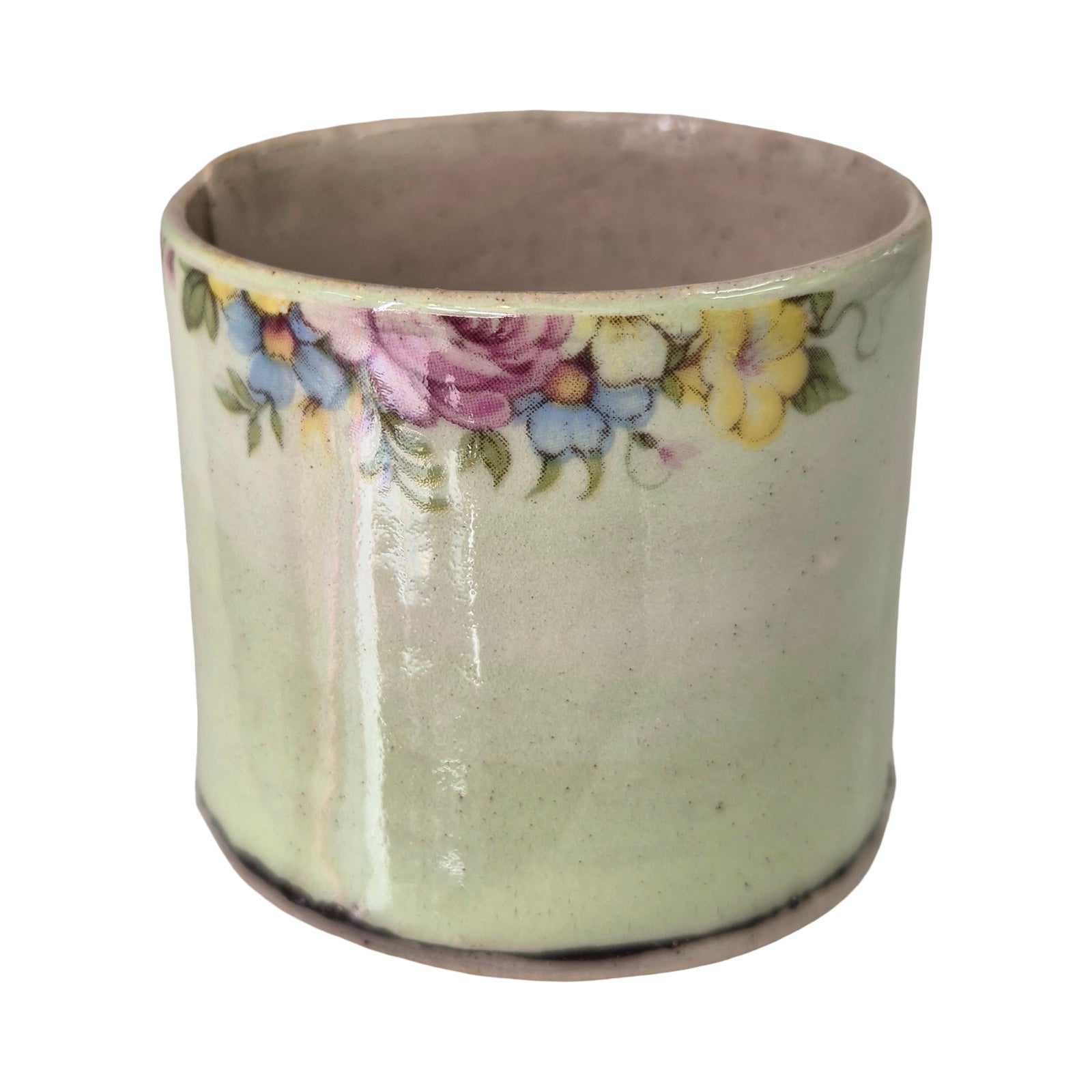 Ceramic planter with floral design on a white background.