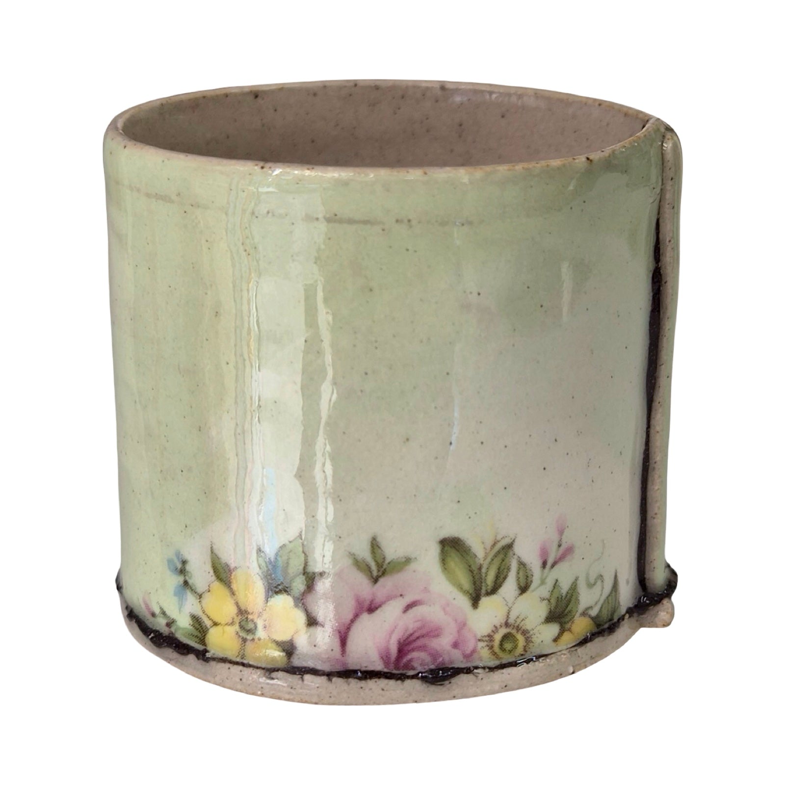Ceramic planter with floral design on a white background.