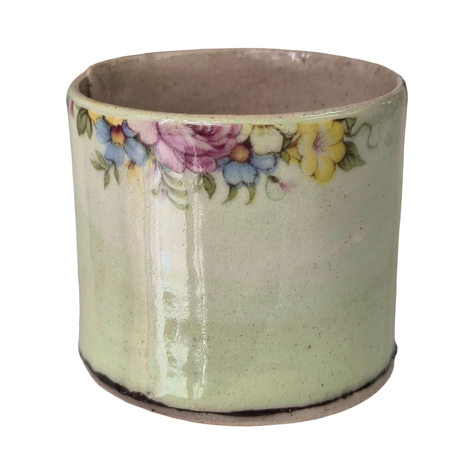 Ceramic planter with floral design on a white background.
