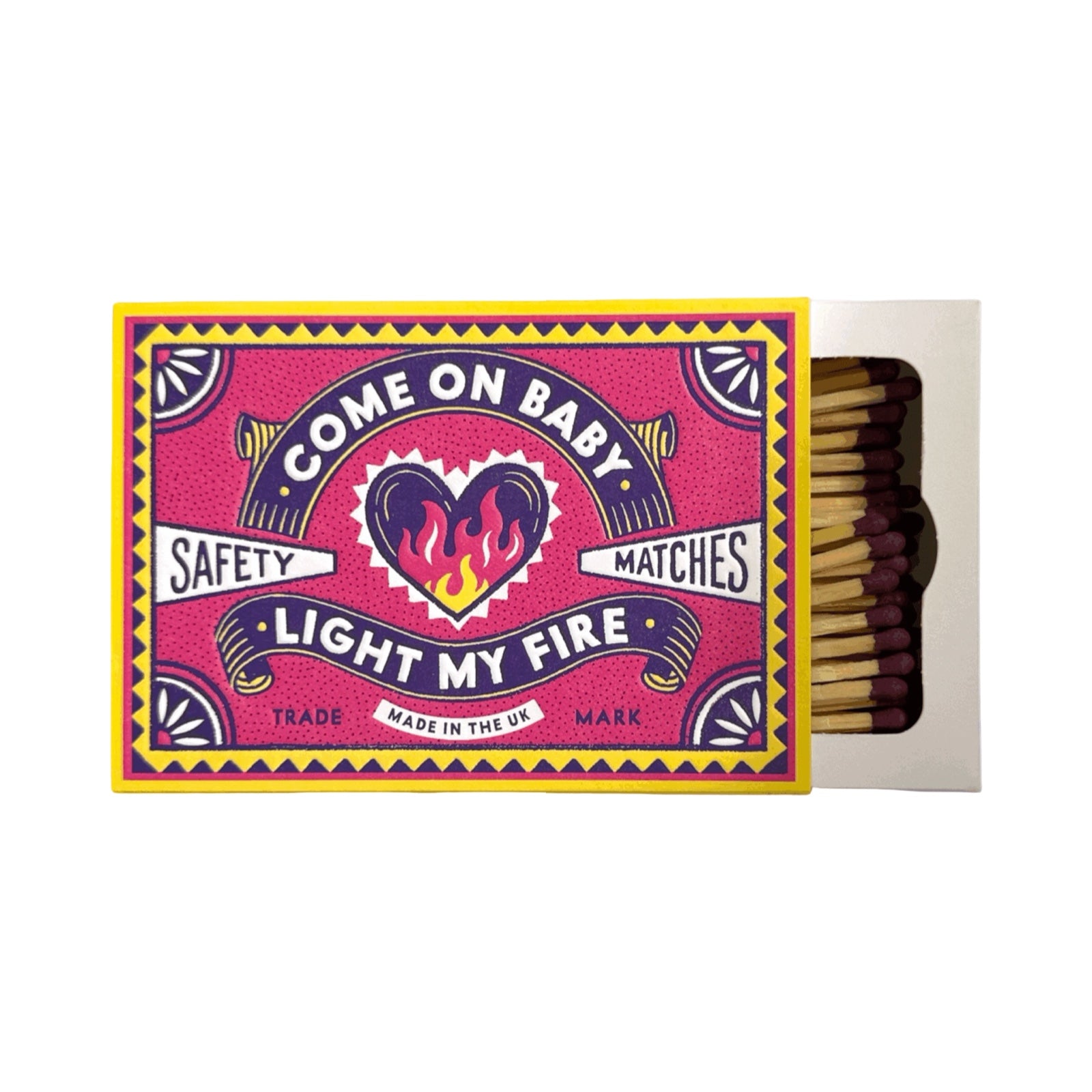 A novelty matchbox with a bright pink cover featuring a colourful flame heart and the text 'COME ON BABY', 'SAFETY MATCHES', and 'LIGHT MY FIRE'. The box is open, showing wooden matches with dark tips inside a white inner box, on a plain white background.