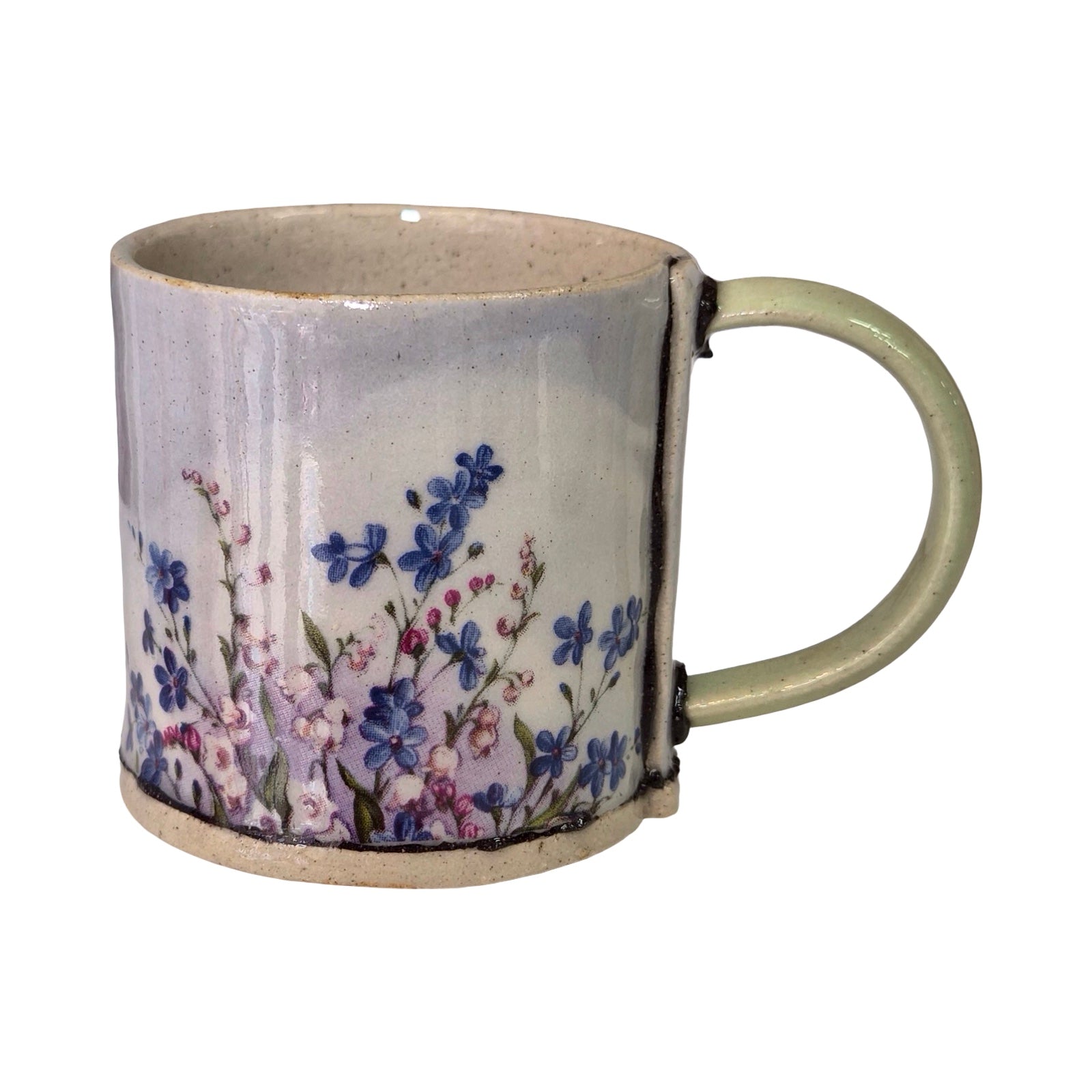 Ceramic mug with floral design on a white background.