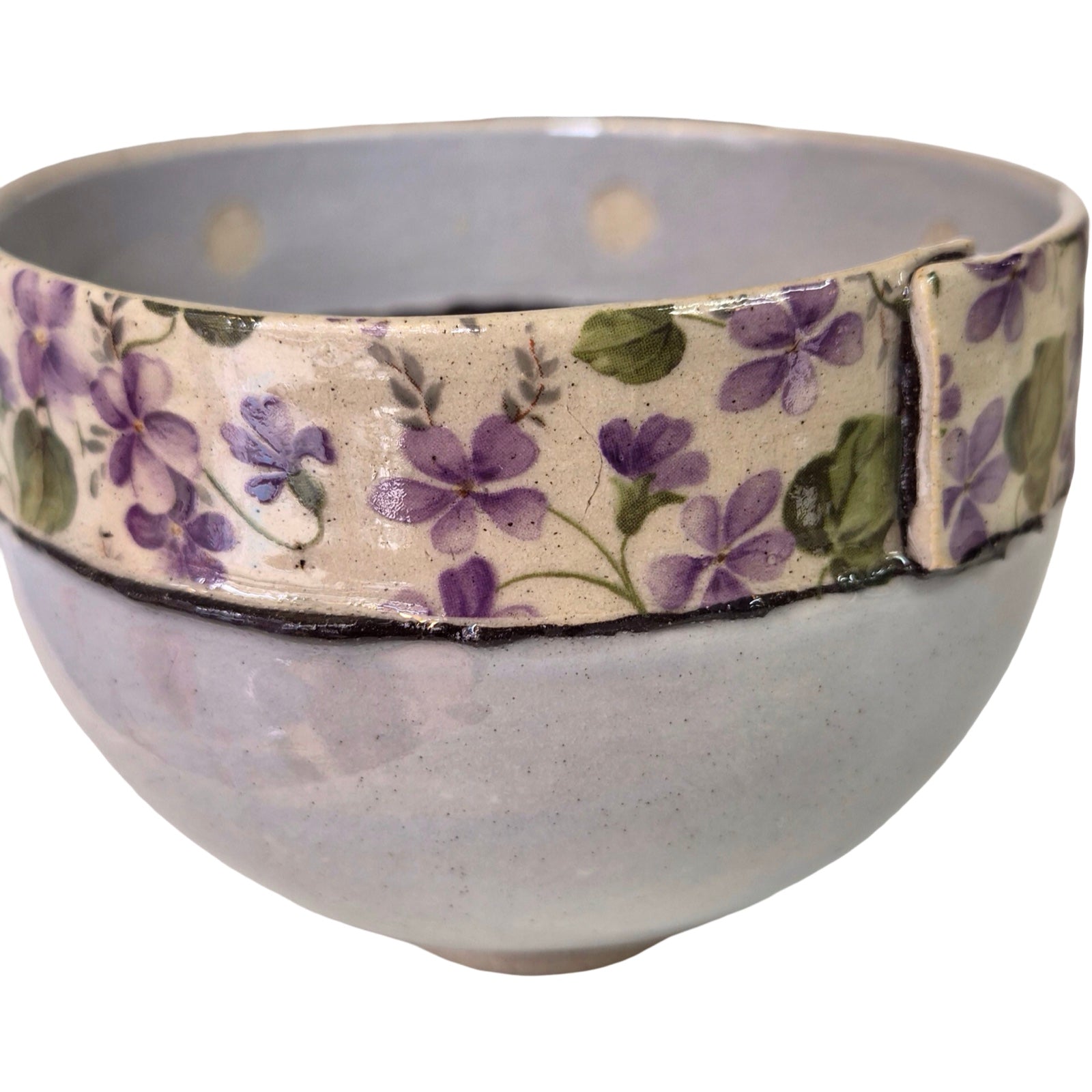 Ceramic bowl with floral band on a white background.