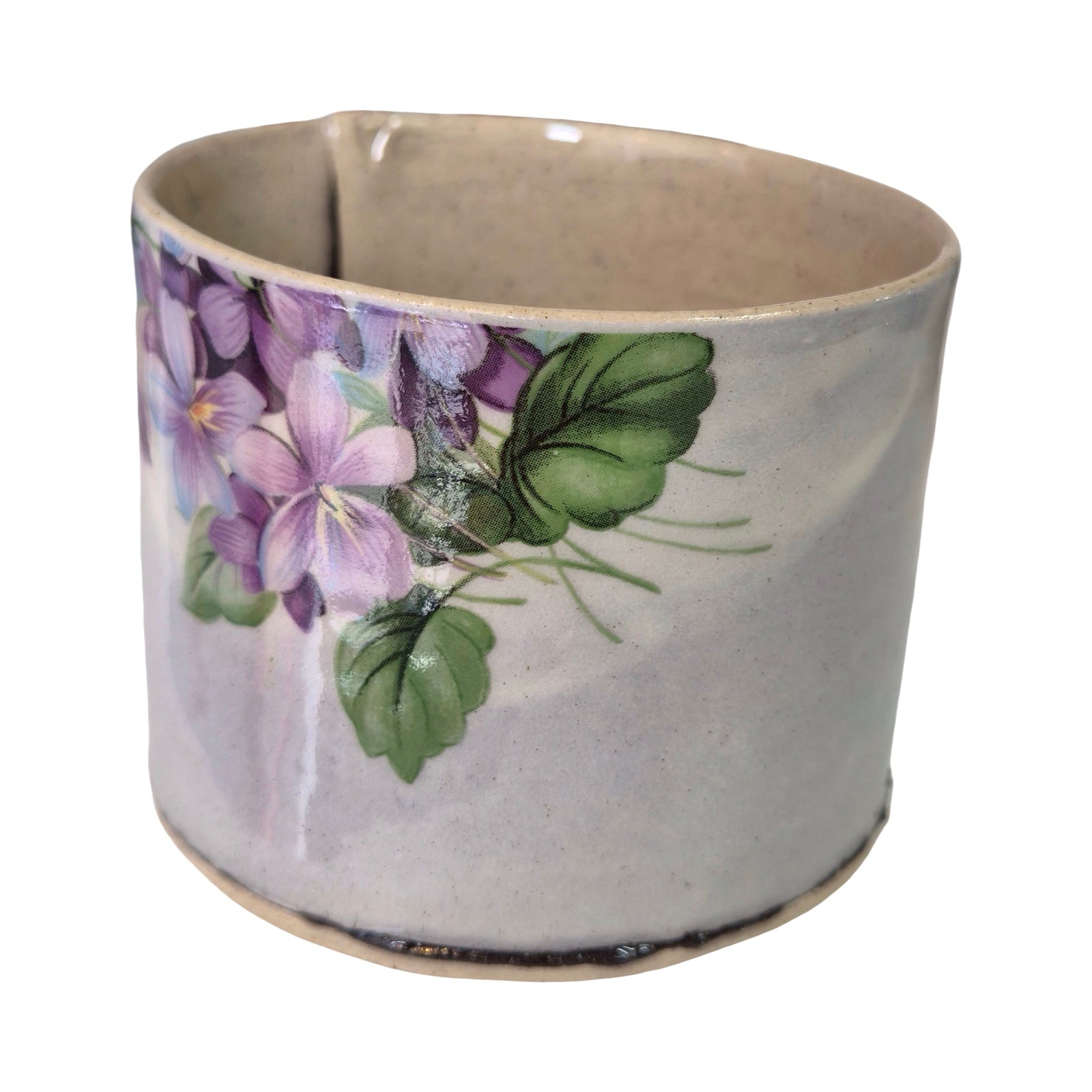Ceramic mug with floral design on a white background.