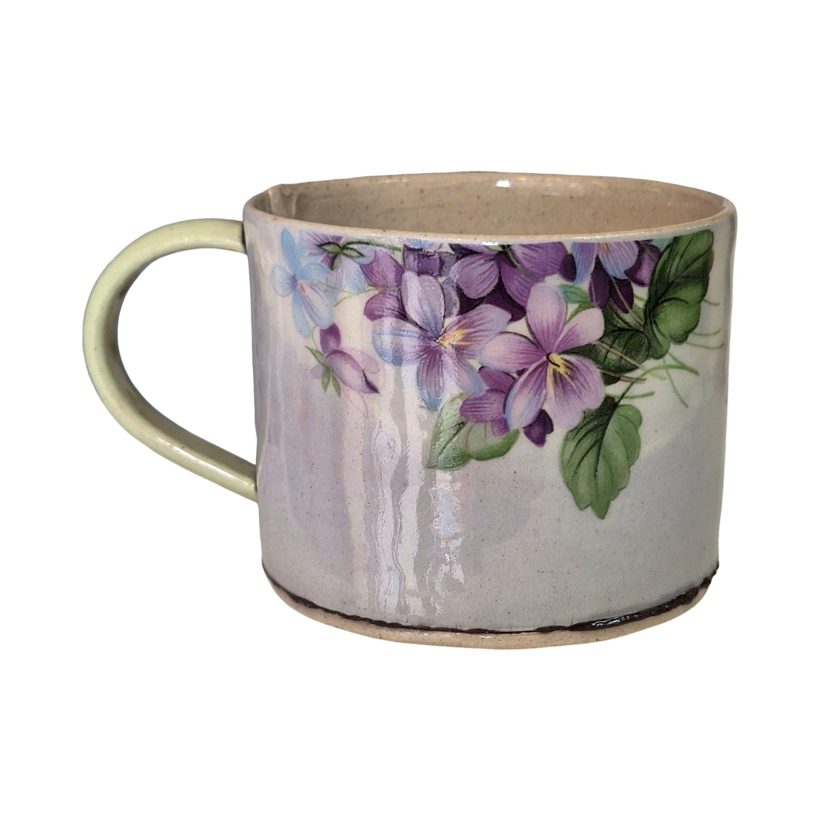 Ceramic mug with purple floral design on a white background.