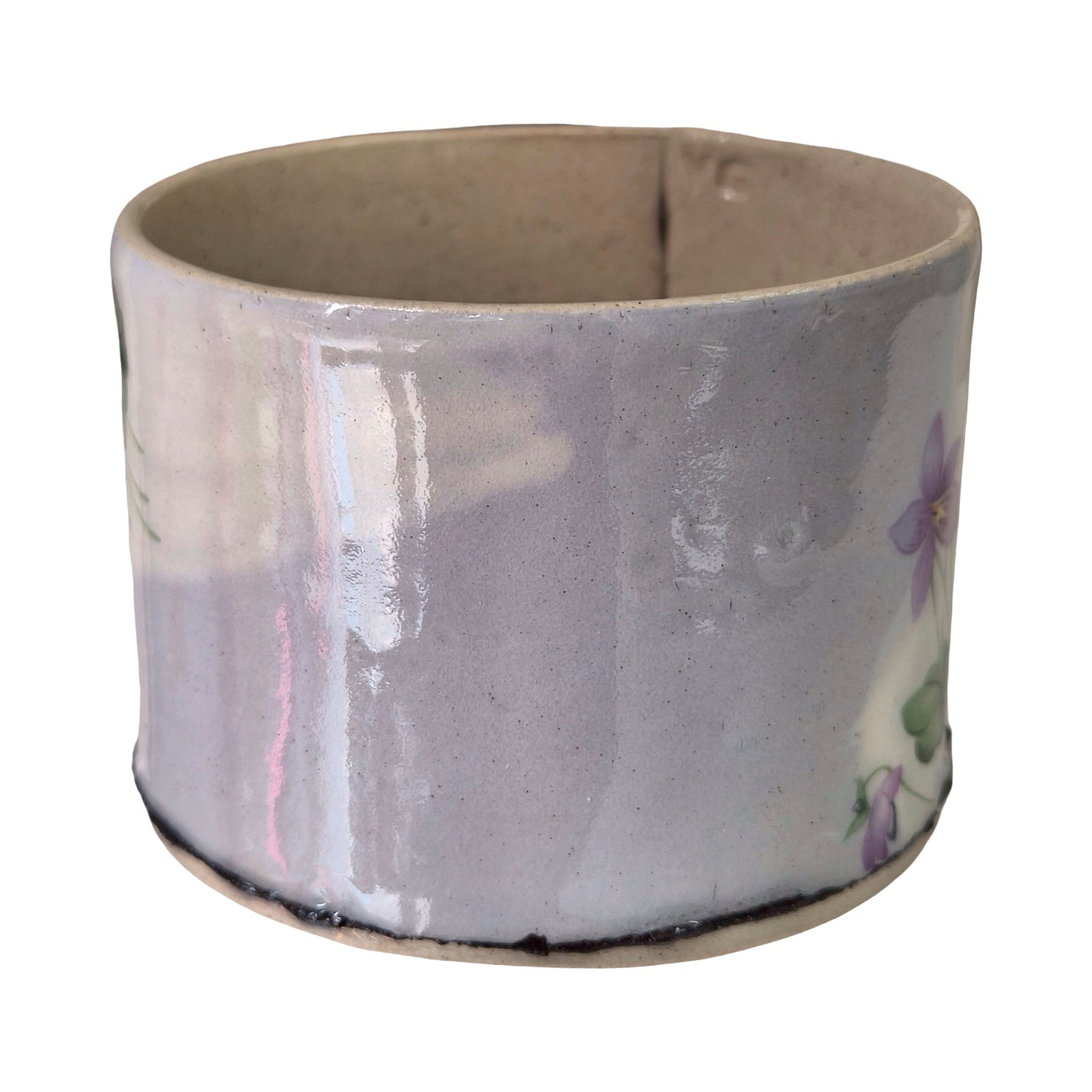 Ceramic planter with floral design on a white background.