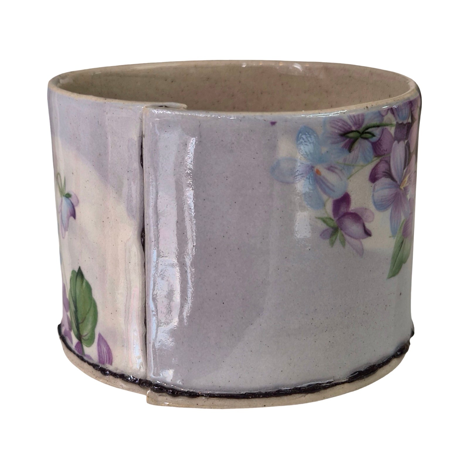 Ceramic planter with floral design on a white background.