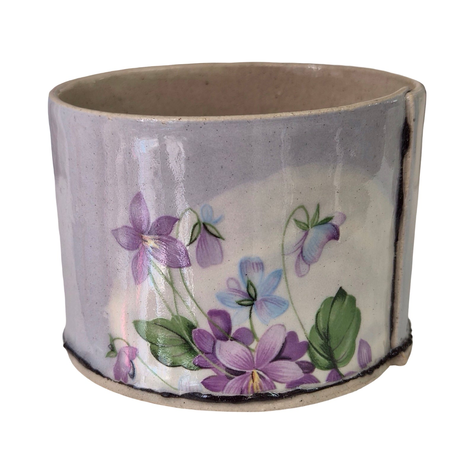 Ceramic planter with floral design on a white background.