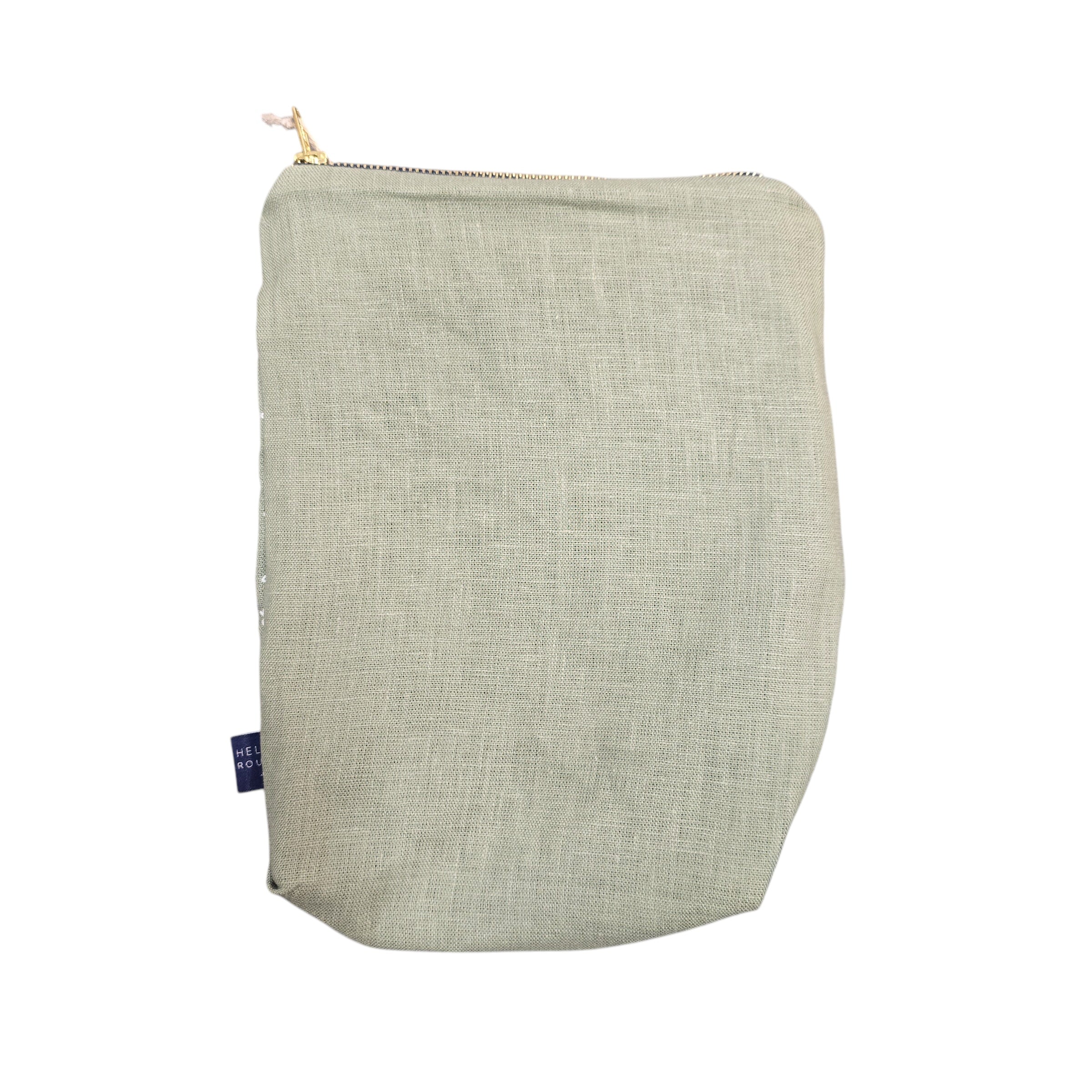 Screen-printed linen toiletry bags with a soft waterproof lining and a brass zip. 