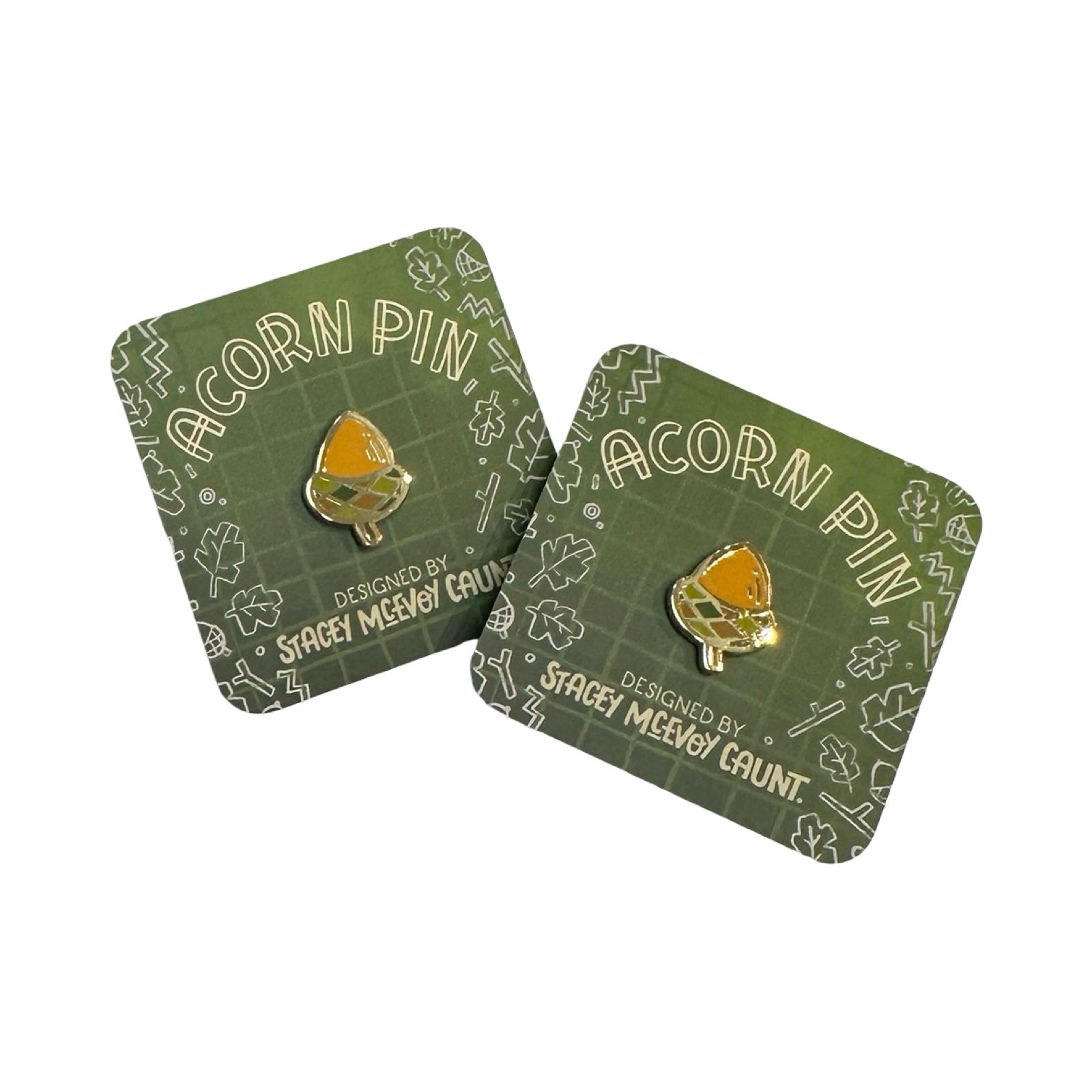 Acorn pin on green card with 'Stacey McEvoy Gaunt' branding.