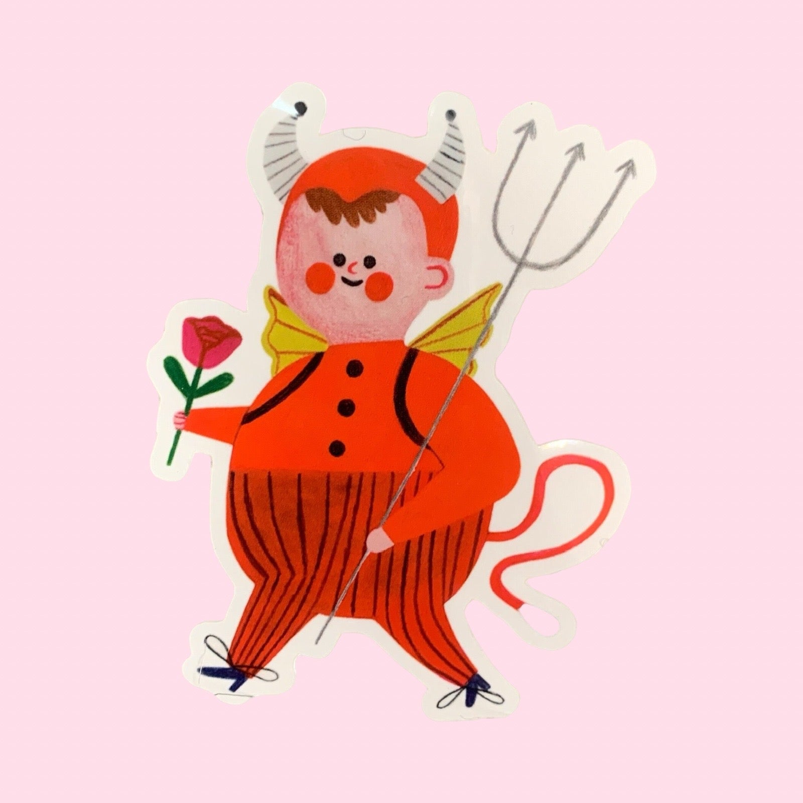 Illustration of a character in a red outfit with horns, a flower, and a pitchfork on a pink background.