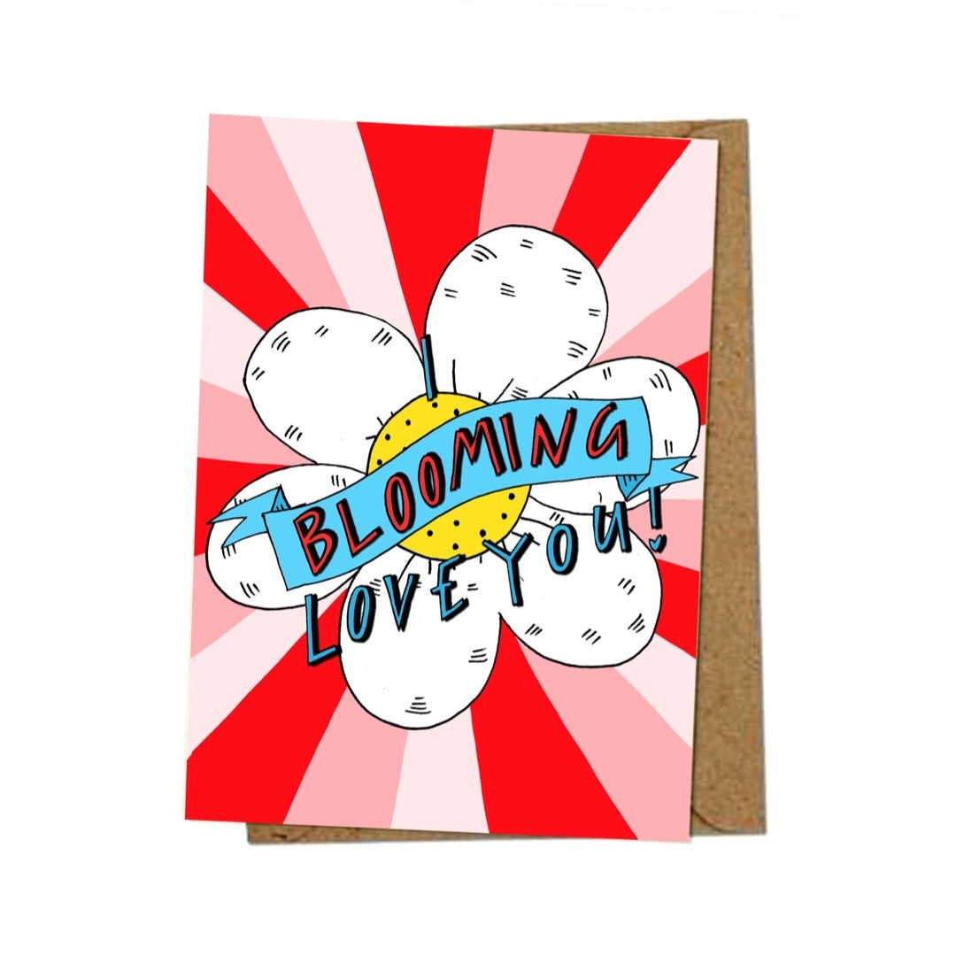 A card full of love featuring an illustration of a large daisy and the text 'I Blooming Love You' written inside on a red and pink background.