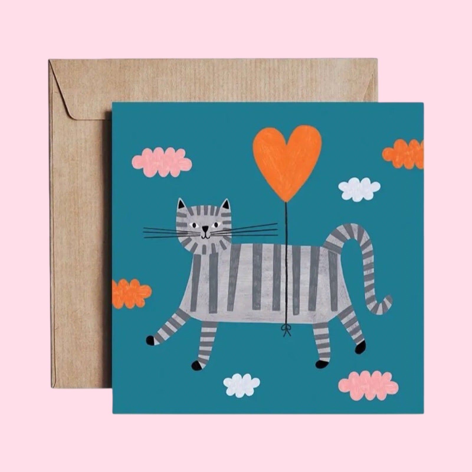 Greeting card with a cat holding a heart-shaped balloon on a blue background, accompanied by a brown envelope.
