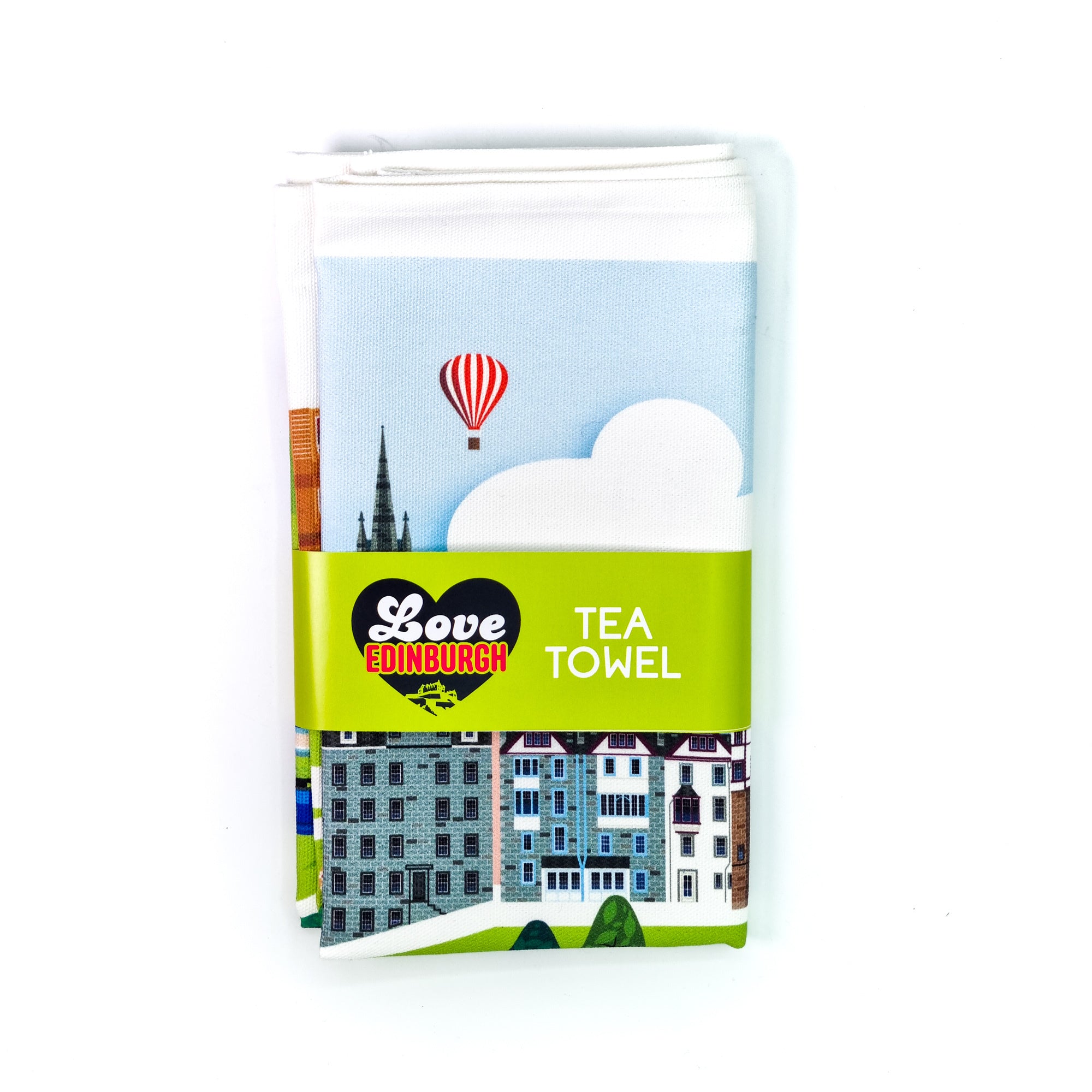 A folded white cotton tea towel with an illustration of various famous landmarks in Edinburgh, including a hot air balloon and a map outline.