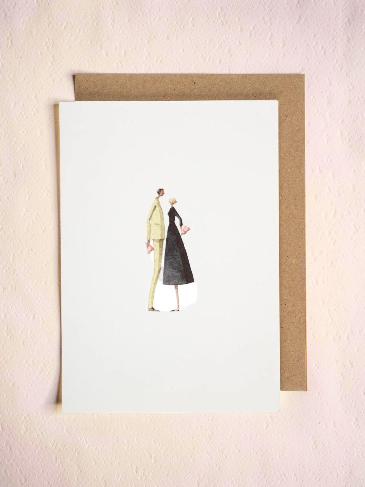 Greeting card with illustration of two people, with a brown envelope on a light pink background.