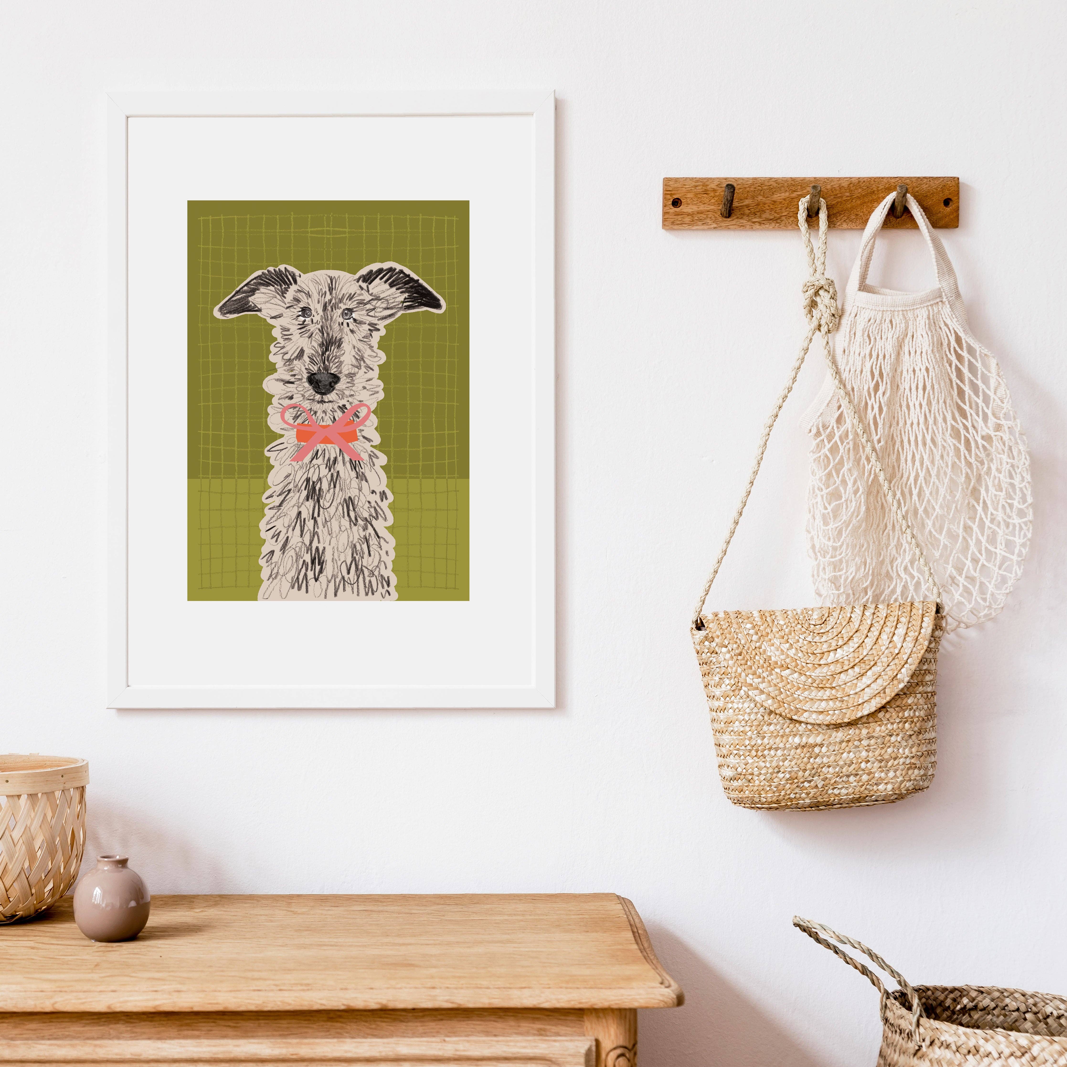 Framed artwork of a dog on a wall with bags hanging below.