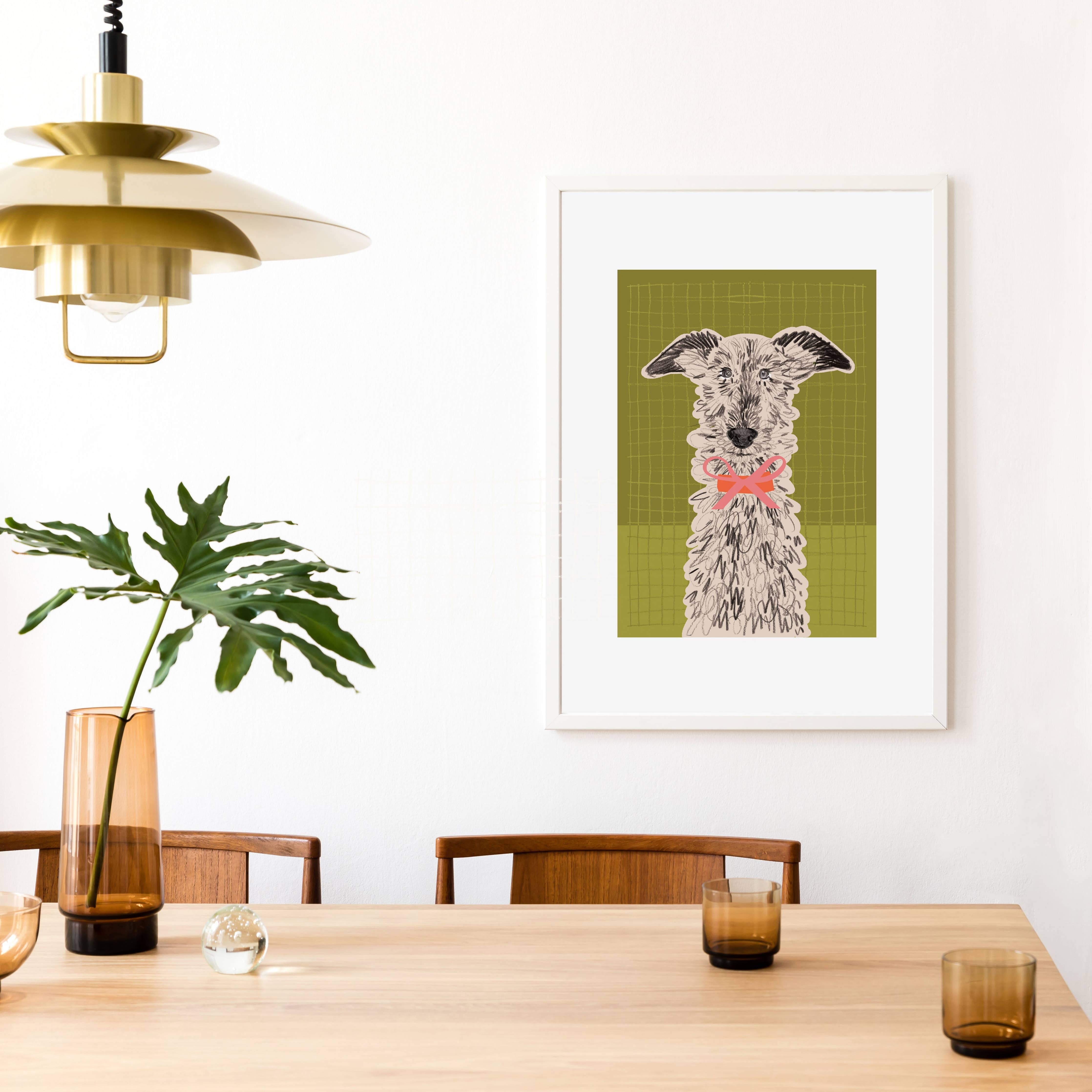 Framed artwork of a dog on a wall above a dining table with decor items.