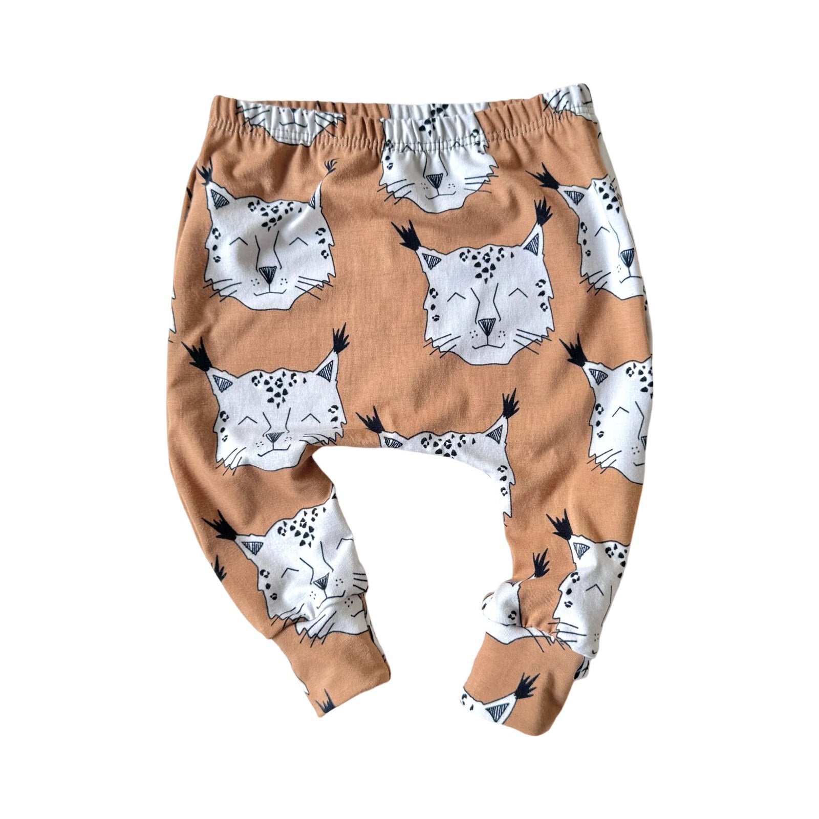 Brown harem leggings with a lynx pattern, featuring a stiff waist elastic and finished with cuffs.