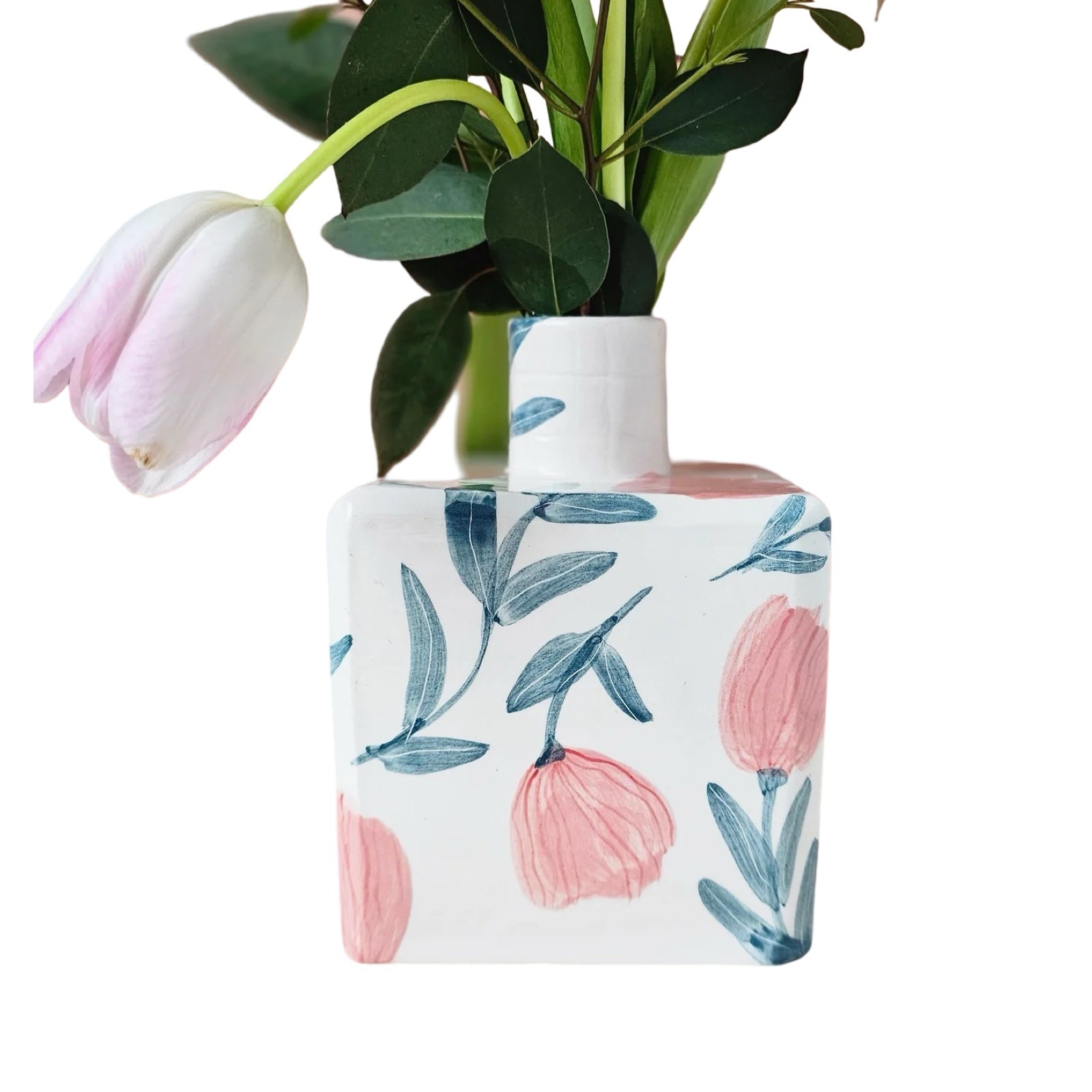 White ceramic vase with pink flowers and green leaves and an illustration of 'Madame Gigi'.