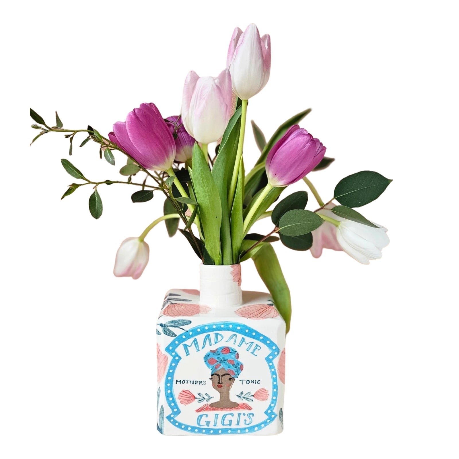 White ceramic vase with pink flowers and green leaves and an illustration of 'Madame Gigi' with a bunch of pink and white tulips inside,