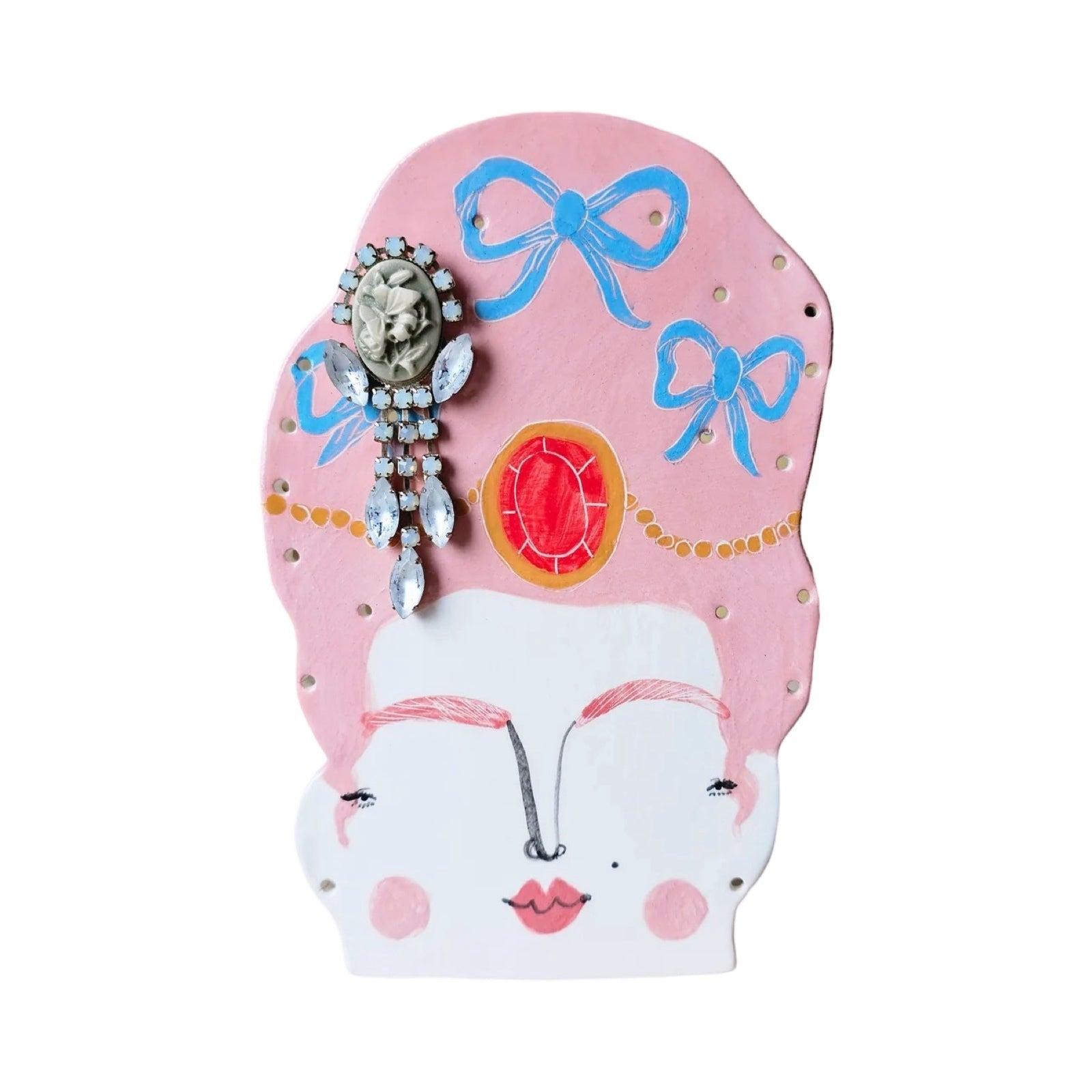 Handmade earring holder shaped like a lady's head wearing a huge pink wig with blue bows in it with holes to hang your earrings from.