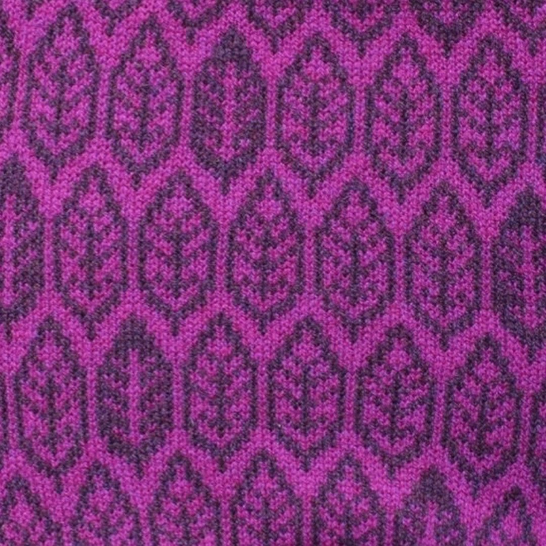 A super soft and cosy 100% lambswool knitted snood in a magenta and purple leaf design.