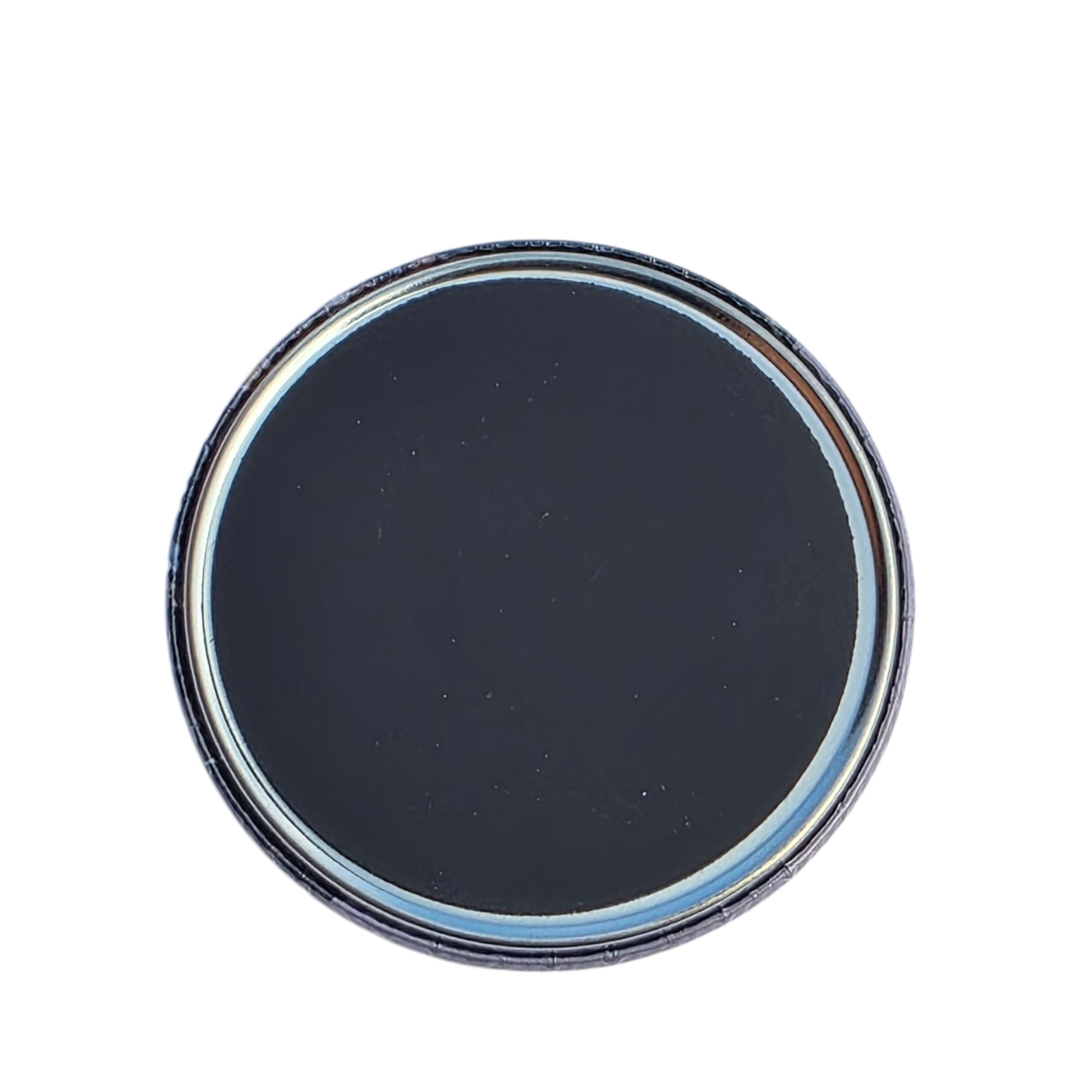 Round magnet back with a metallic rim on a white background
