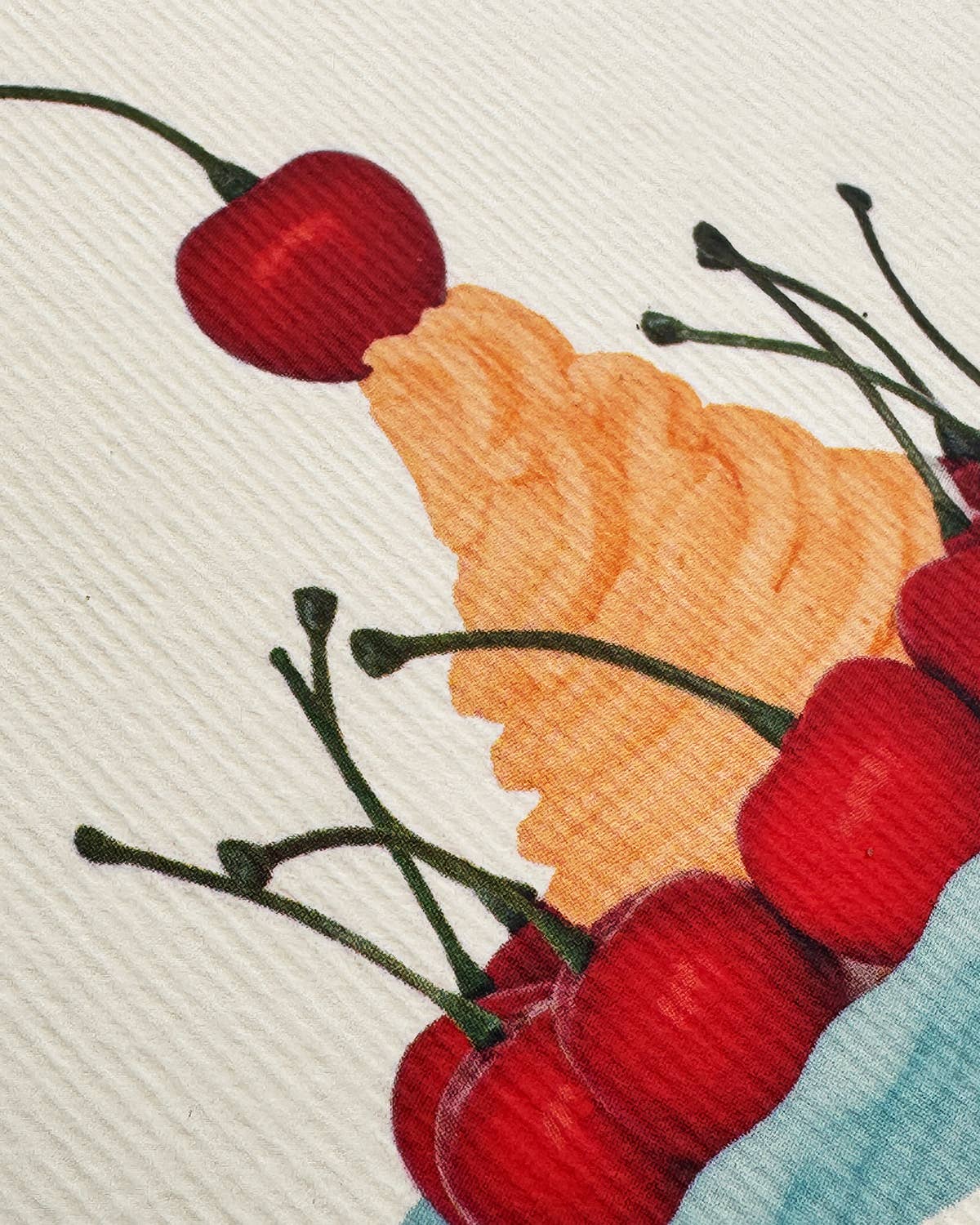Close up of cherries and a leaf on a textured background.