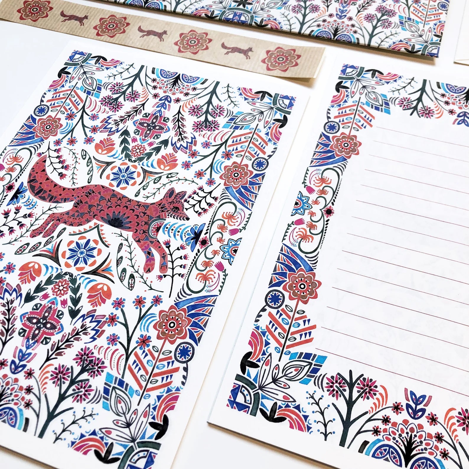 Colorful stationery set with floral and animal designs on a white background.